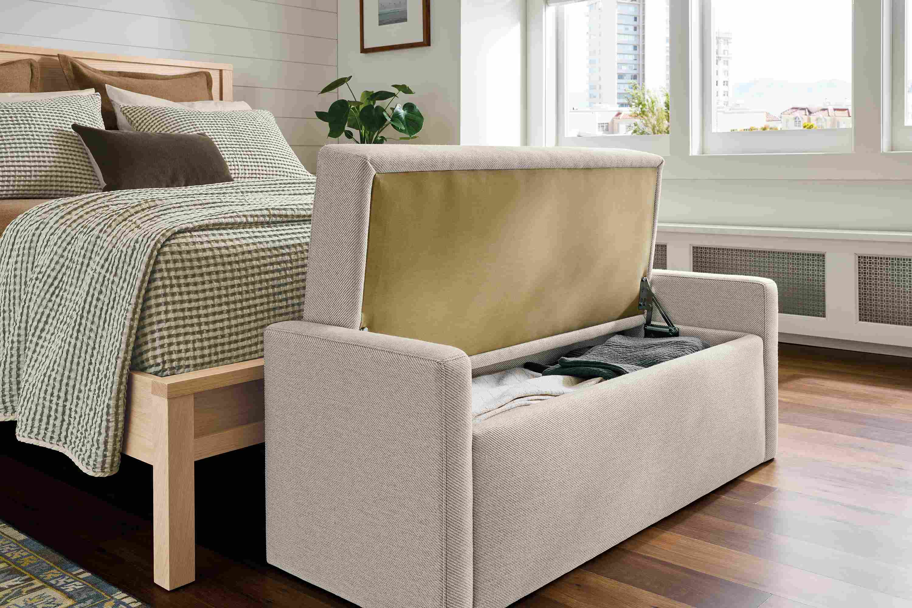 Bedroom showing an open blakely 48-wide storage bench in derry natural and emerson queen bed.
