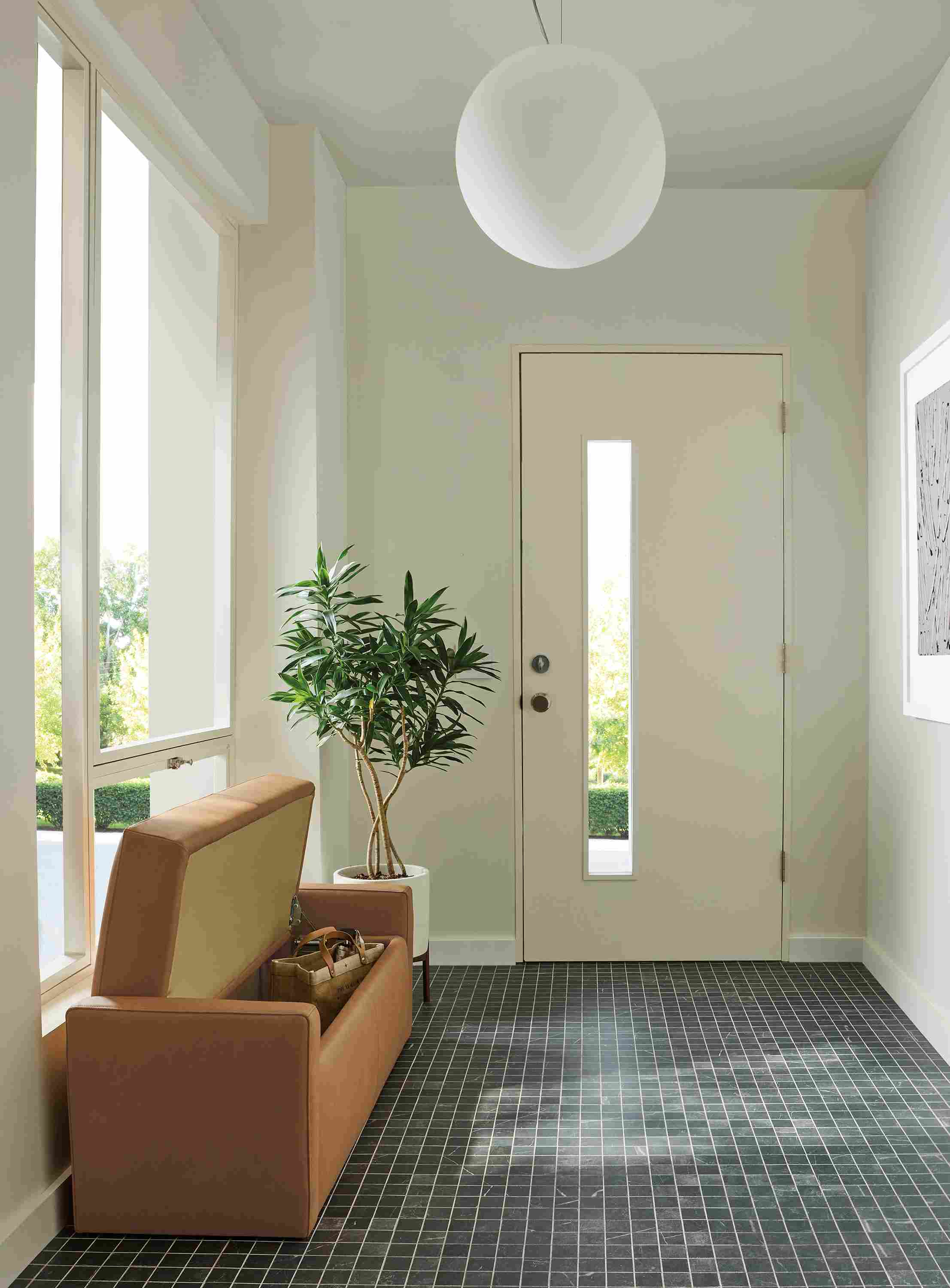 Entryway with Blakely 48-wide storage bench in Laino Camel leather shown with top open and Sfera pendant light.