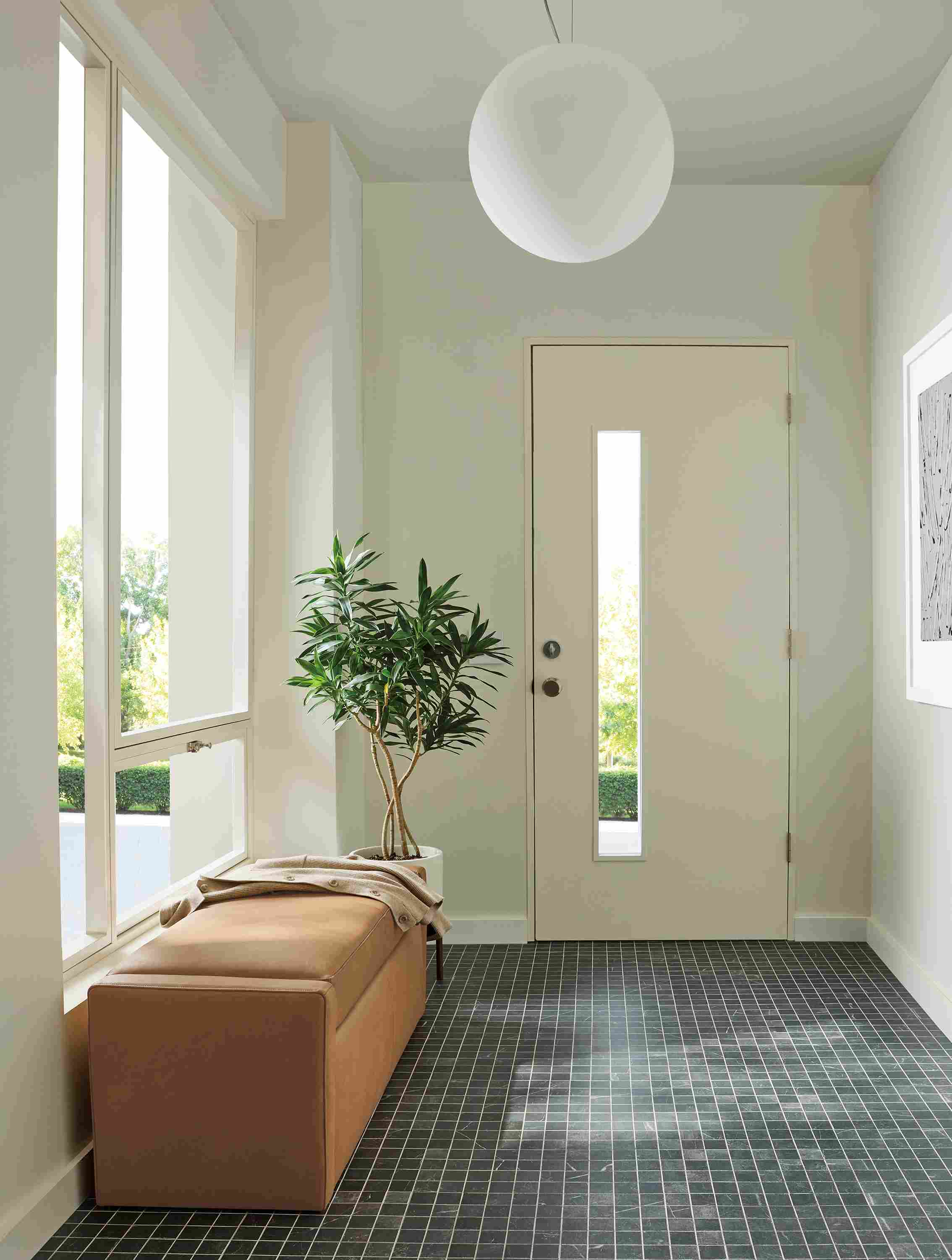 Entryway with Blakely 48-wide storage bench in laino camel leather and sfera pendant light in white.