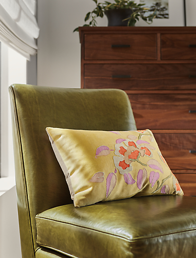Room setting of Blossom 20w 13h throw pillow in lemon with Bree chair in Vento olive leather.