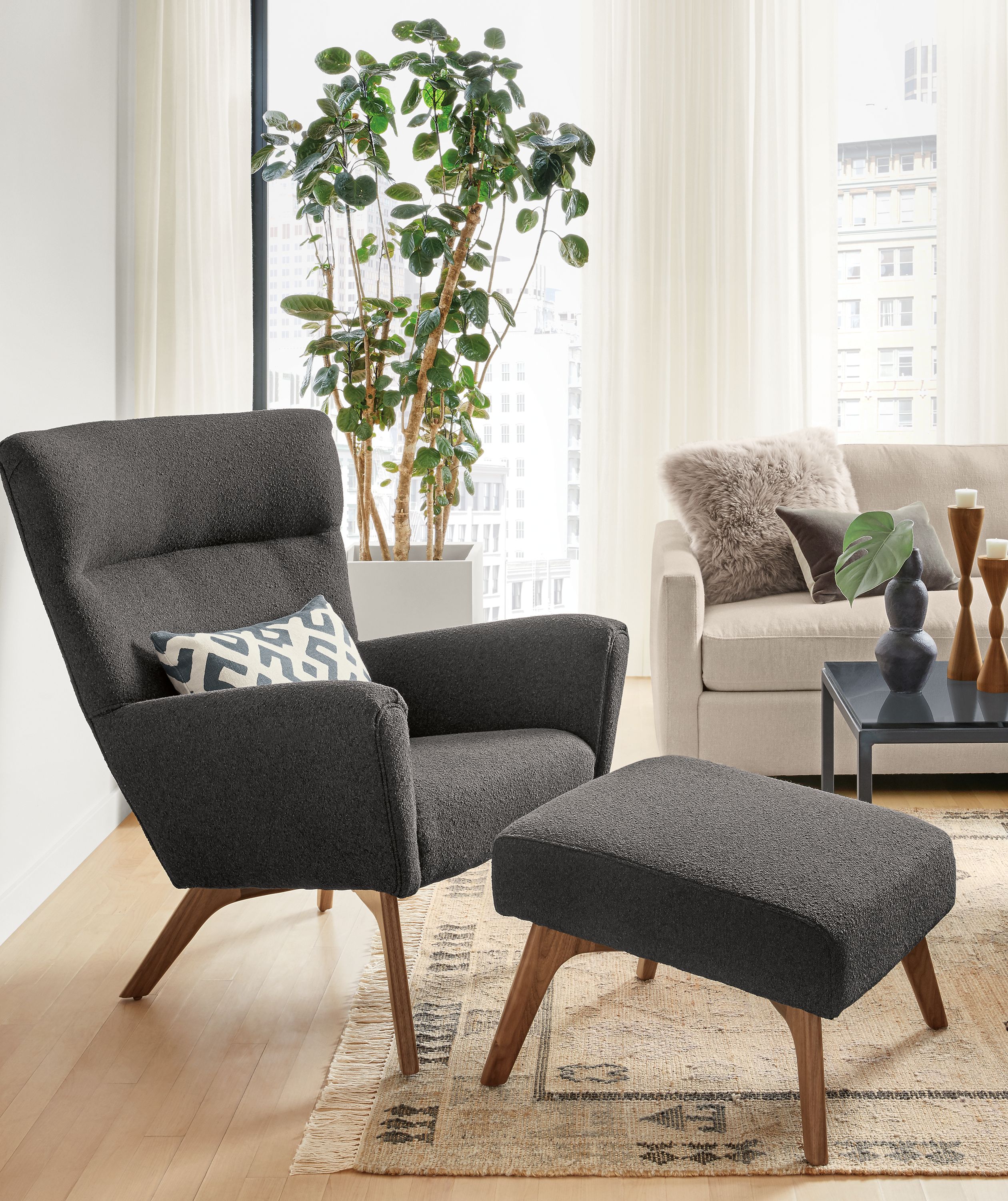 Detail of Boden chair in Declan Graphite fabric with Boden ottoman in living room.