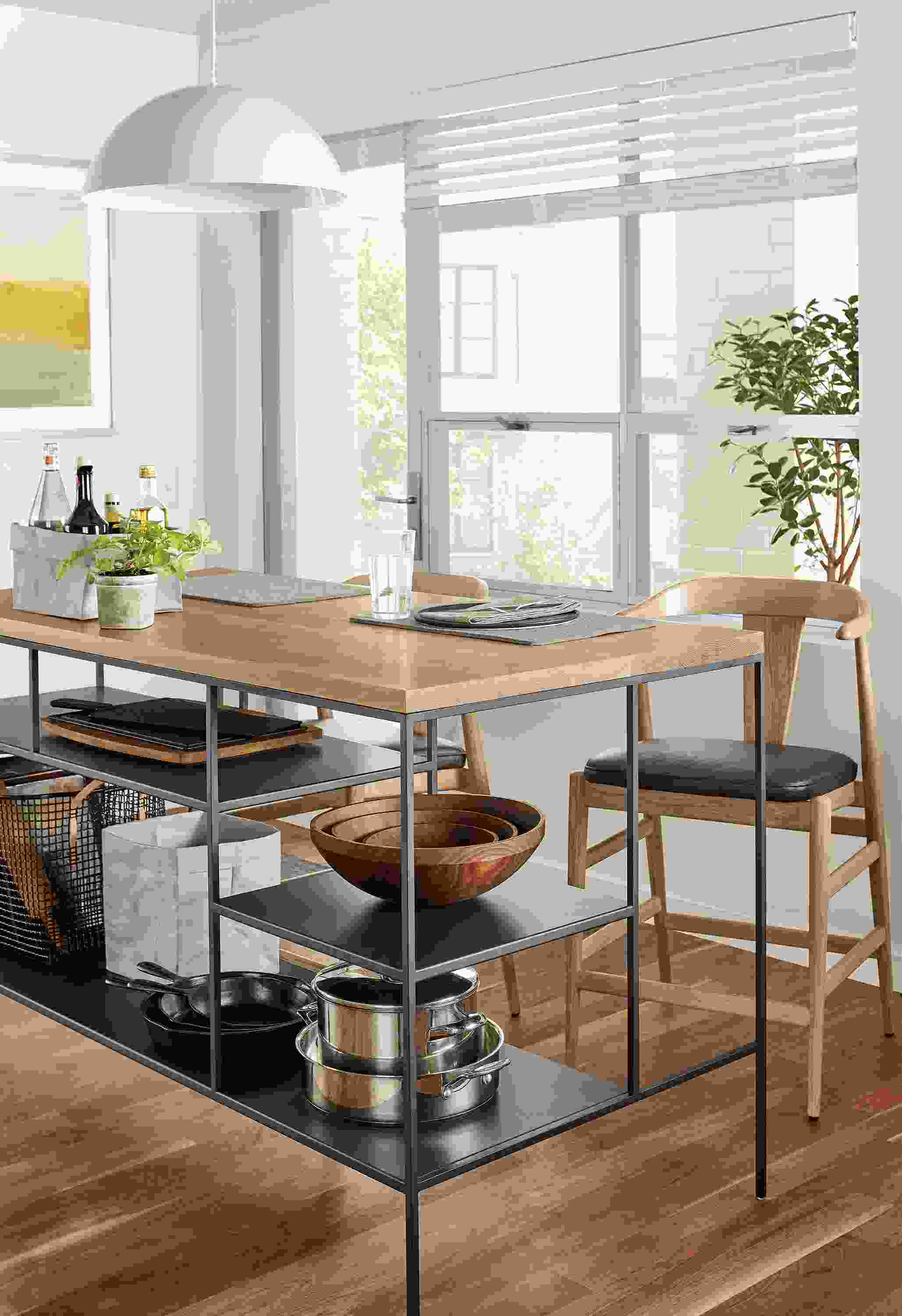 Kitchen with Bowen 60-wide counter table in graphite with rye on red oak top and 2 Evan counters stools in rye on red oak.