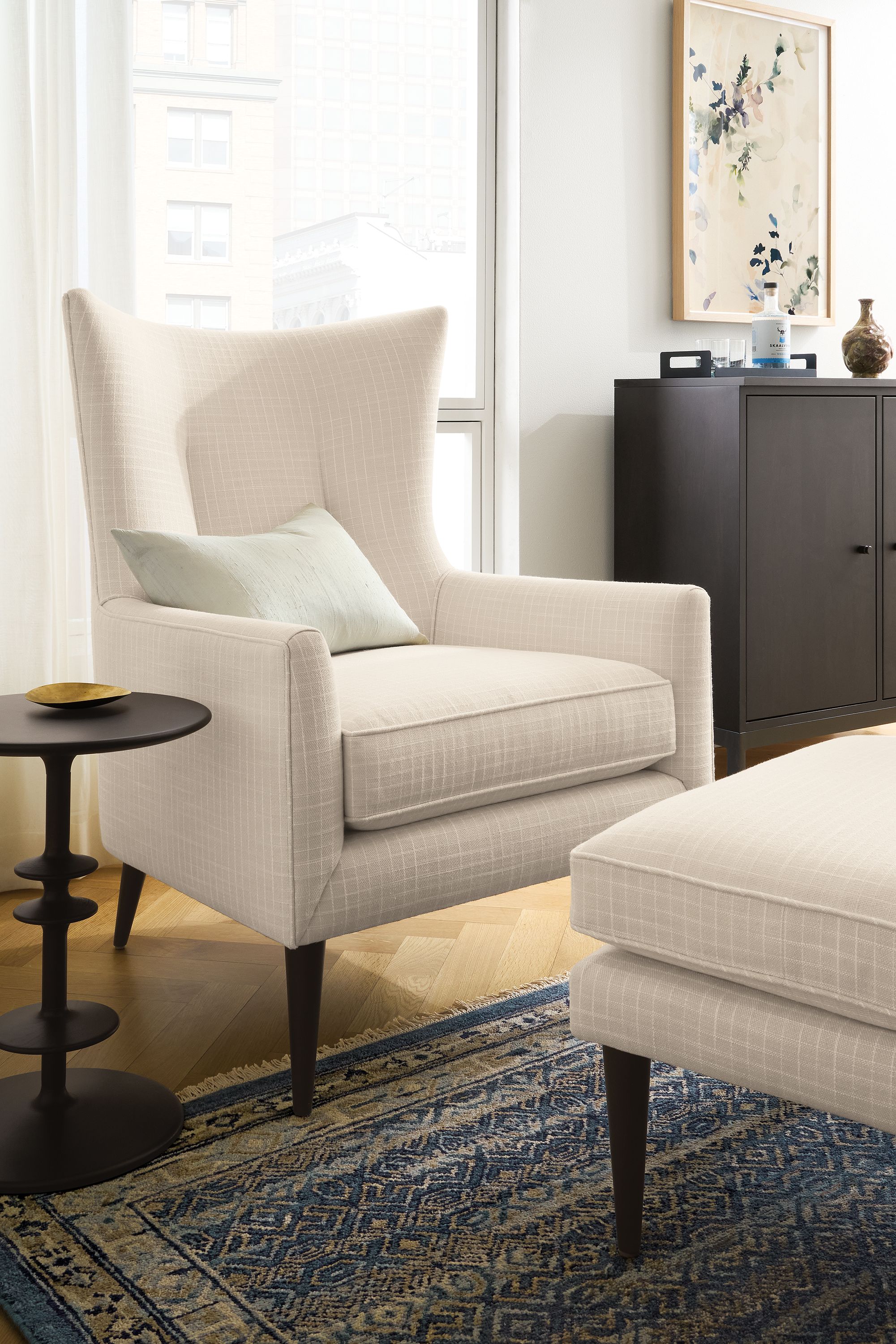 Living room with bradford chair and ottoman in prado natural and anza 8 by 10 rug in marine.