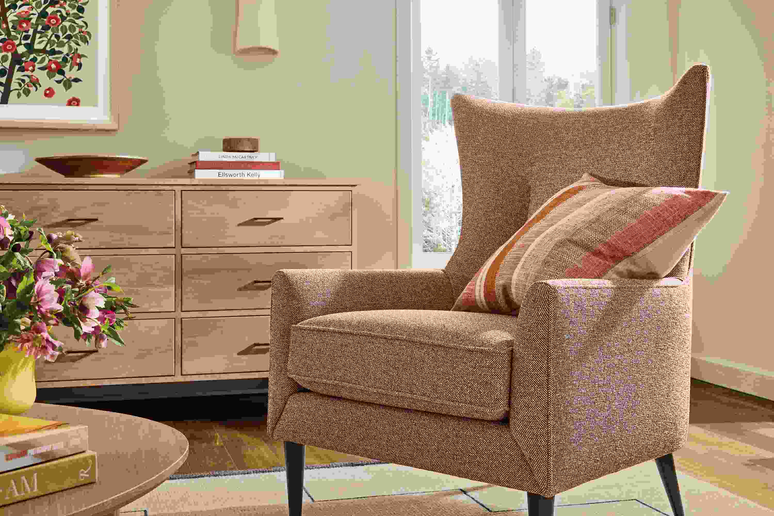 Living room with Bradford chair in Tatum Clay, Linear 12-drawer dresser in rye on red oak and Navi rug in Ivory/Black.