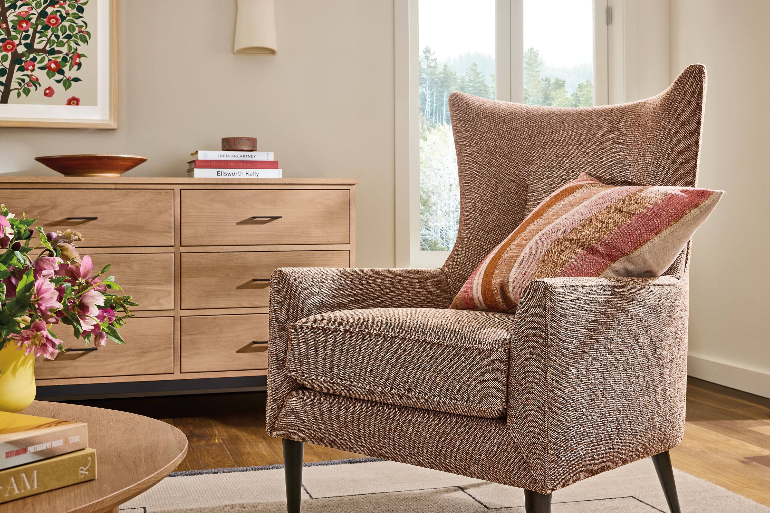 Living room with Bradford chair in Tatum Clay, Linear 12-drawer dresser in rye on red oak and Navi rug in Ivory/Black.