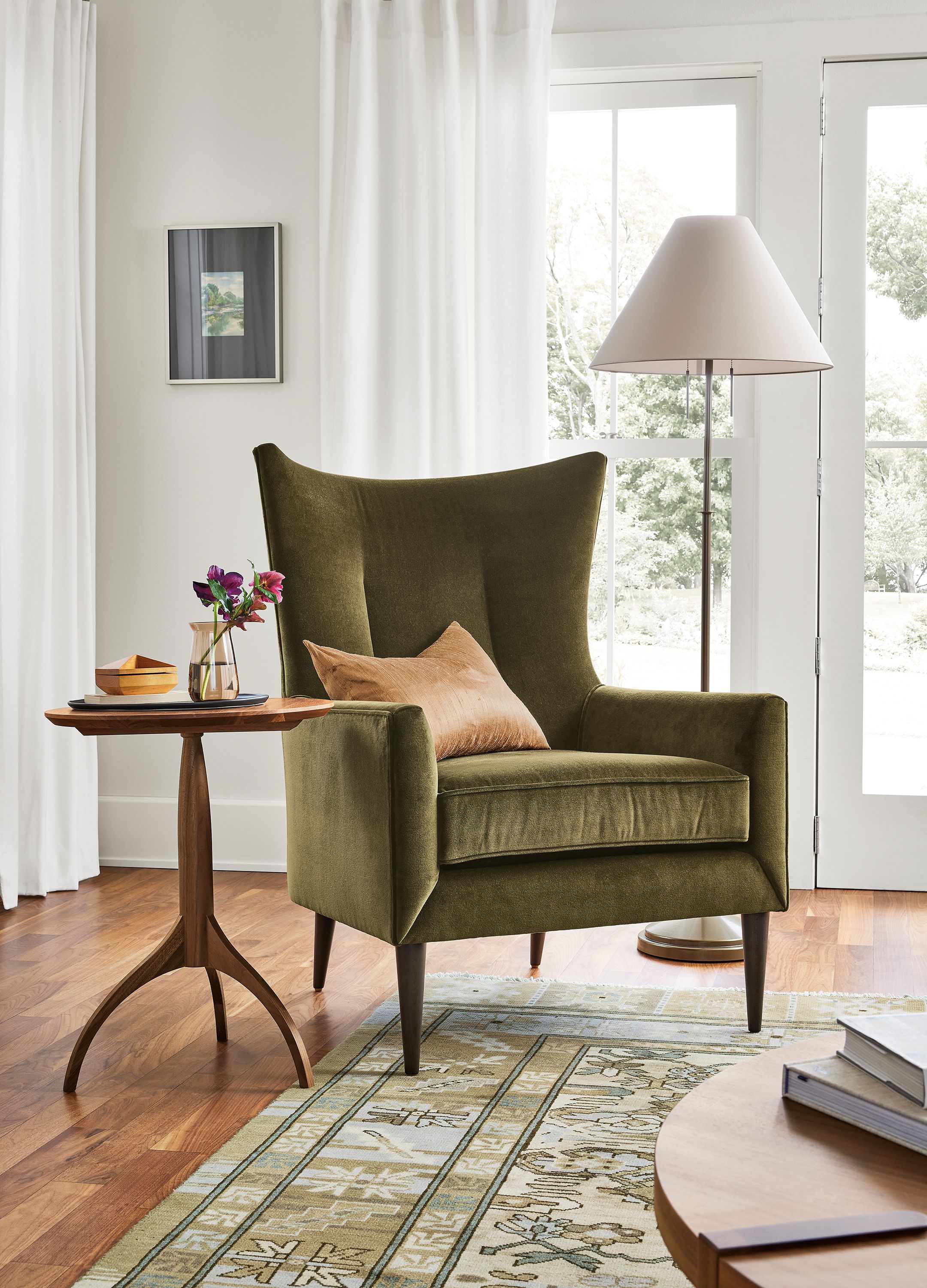 Living room with bradford chair in Redding Olive and adams table in walnut.