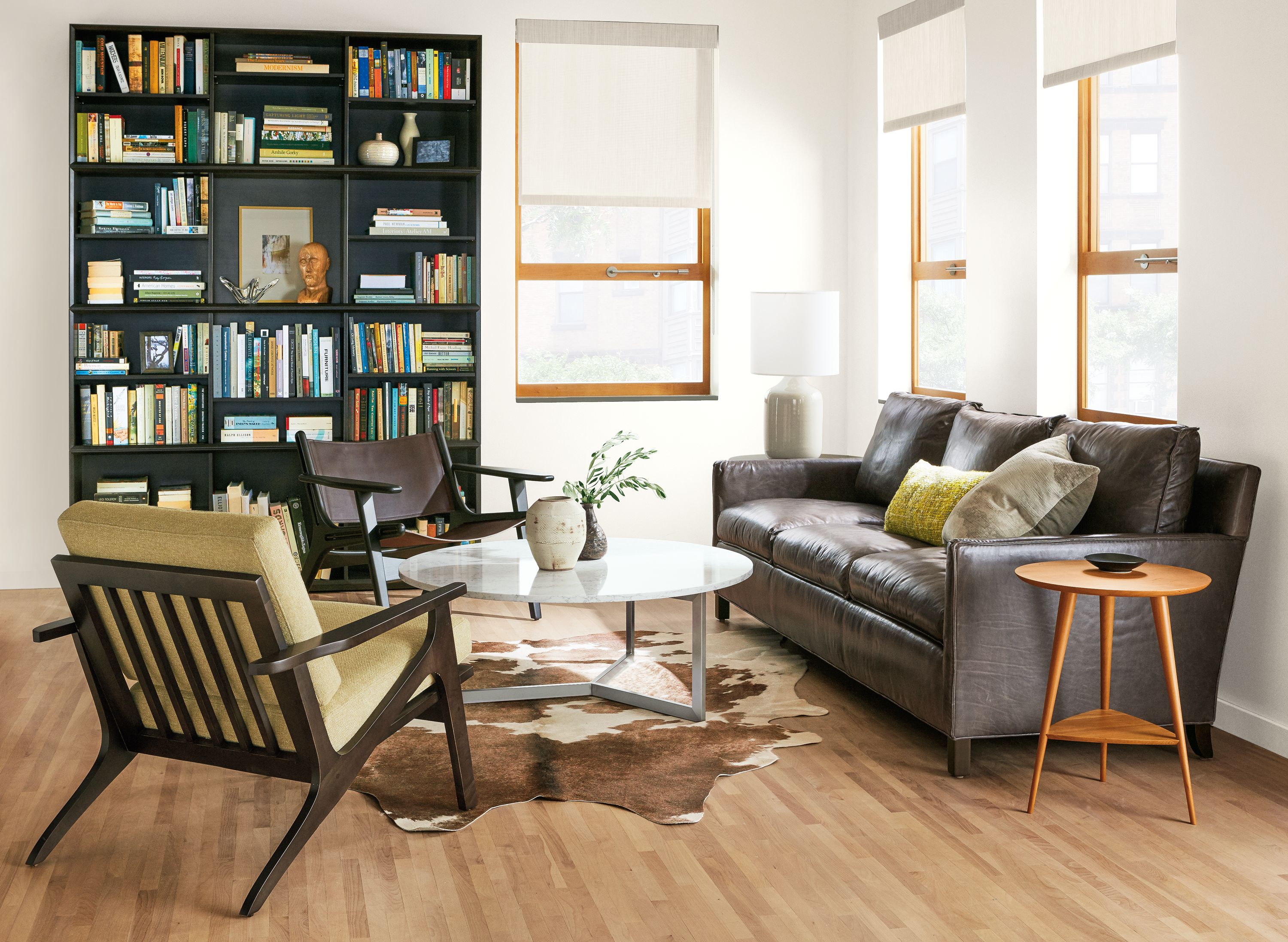 Modern living room with leather and fabric sofa and chairs.