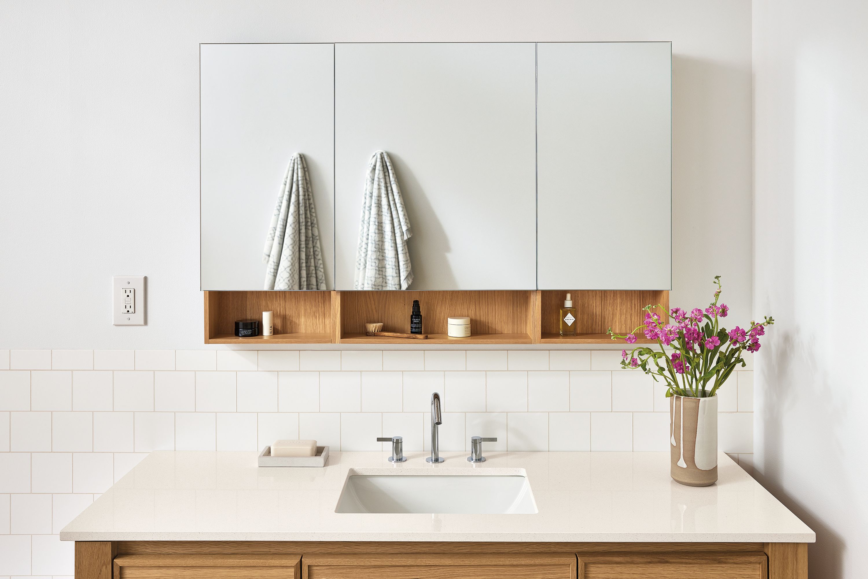 Bathroom with Bridger 46.5 wide, 3-door medicine cabinet and Amherst 60 wide vanity in white oak.