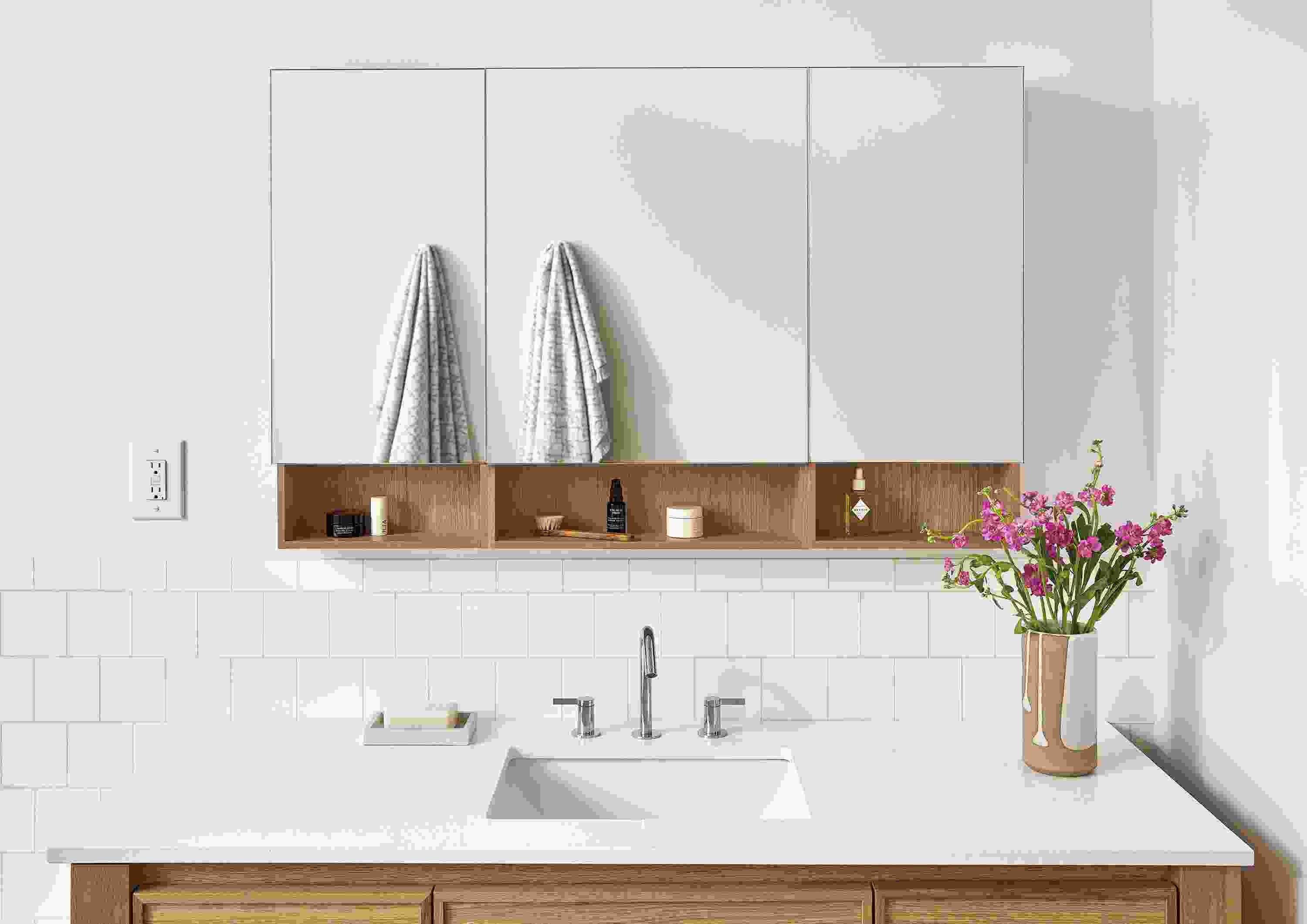 Bathroom with Bridger 46.5 wide, 3-door medicine cabinet in rye on red oak and amherst vanity in white oak with white quartz top.