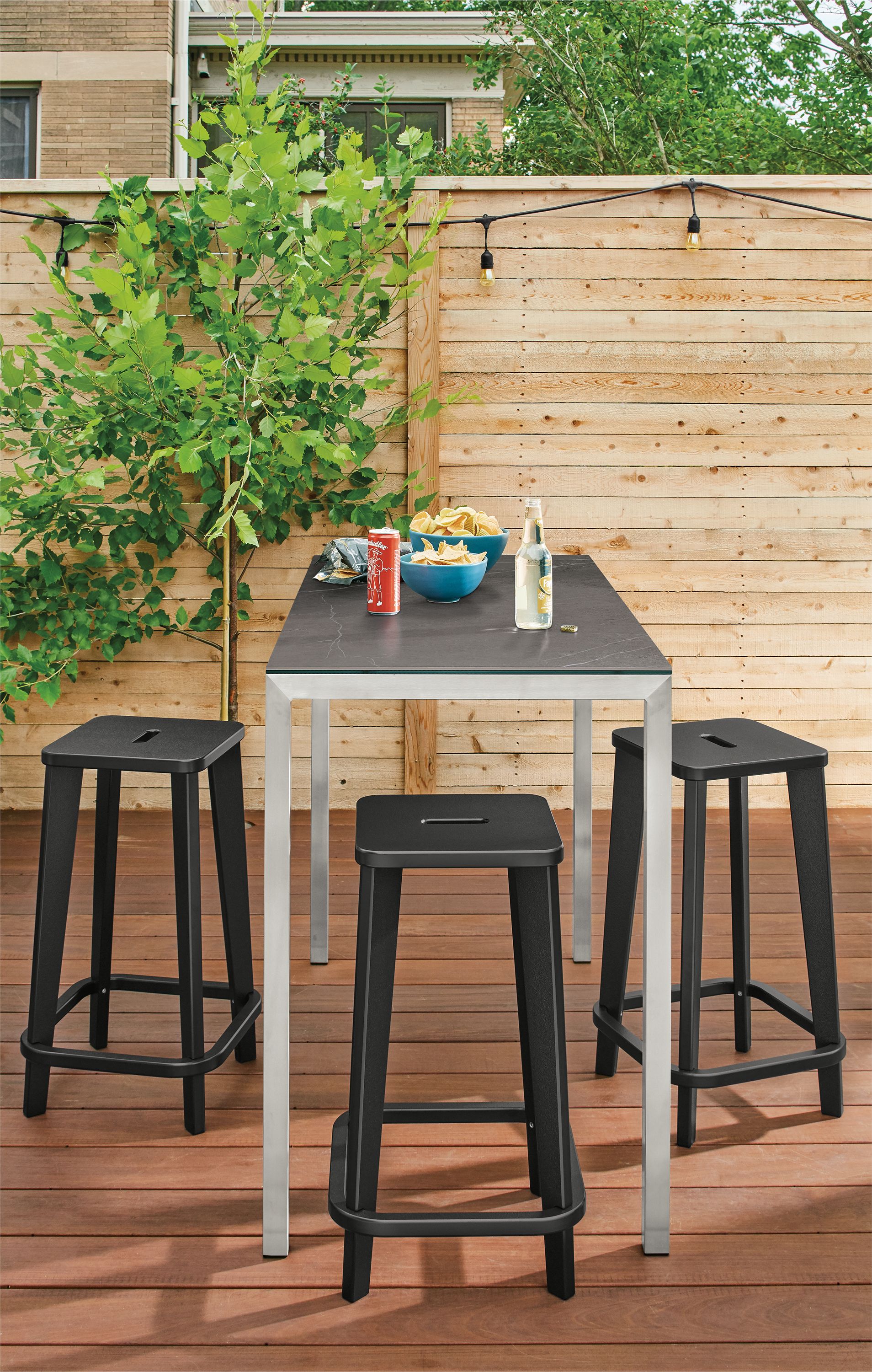 Detail of 3 Brook counter stools at table on deck.