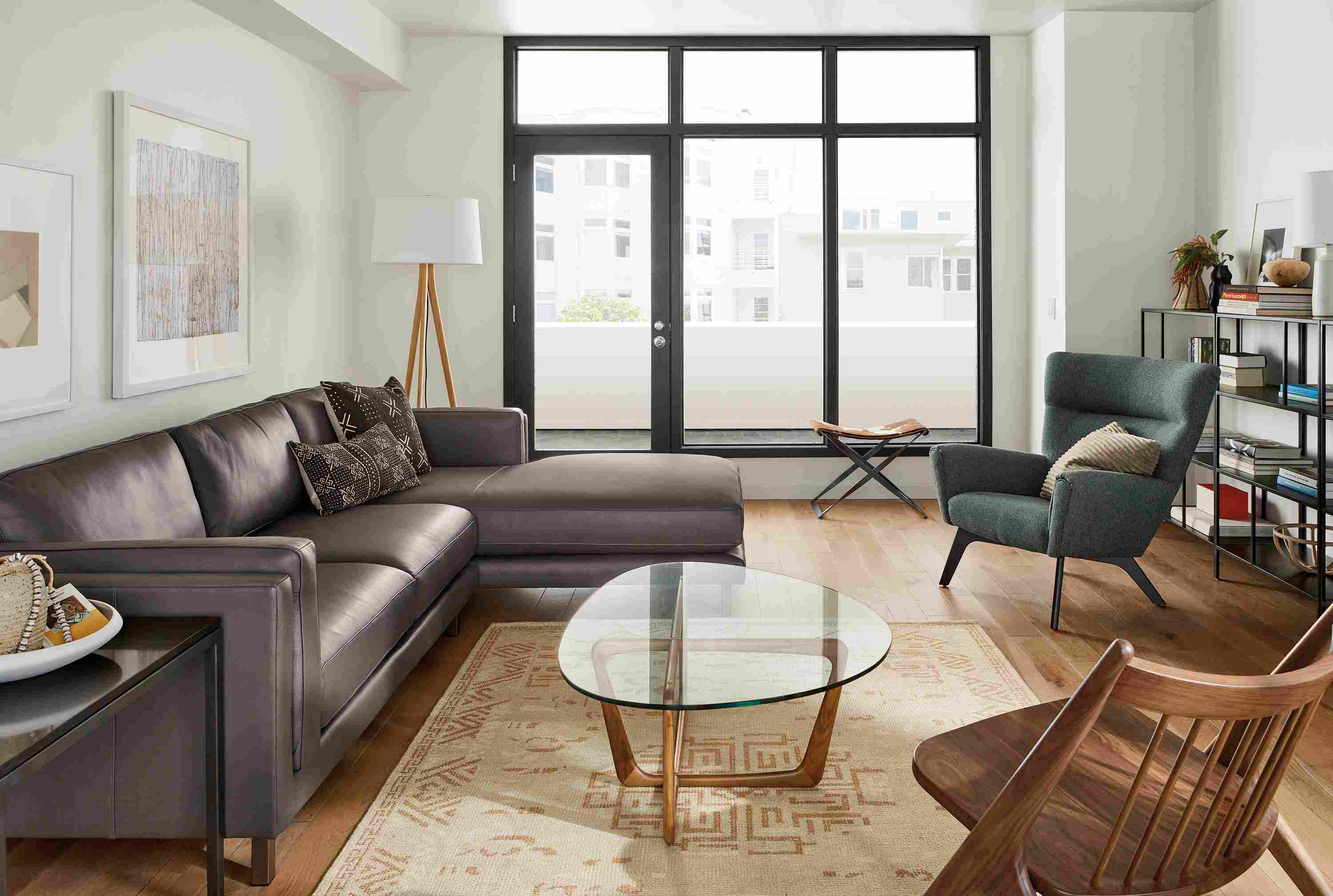 Living room with Cade 114-wide sofa in urbino smoke and  Amira 6 x 9 rug in camel.