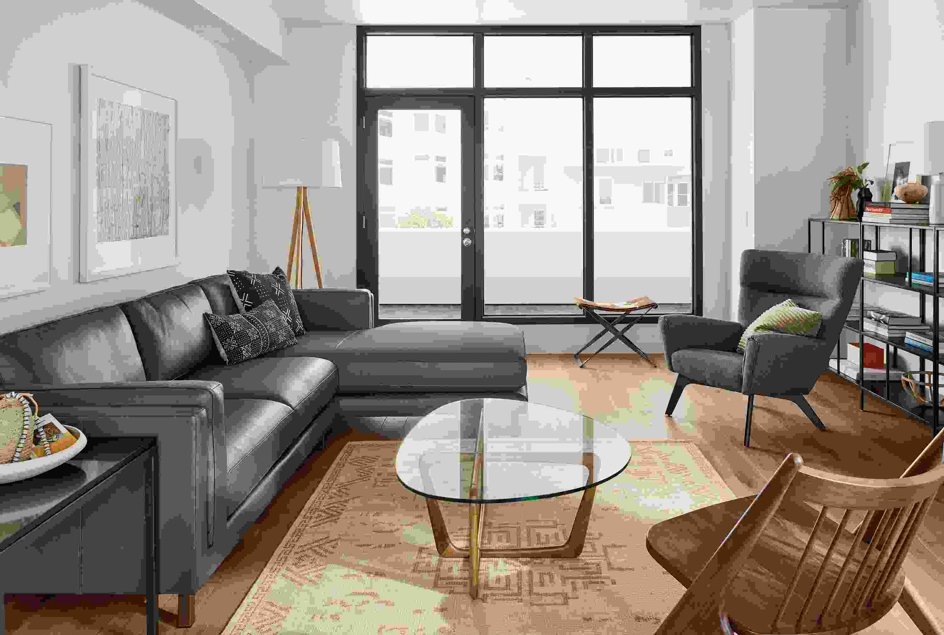 Living room with Cade 114-wide sofa in urbino smoke and  Amira 6 x 9 rug in camel.