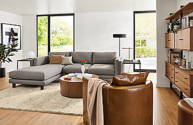 living room with 114-wide cade sofa with chaise in flint fabric, silva chair in vento leather, beam wall unit.