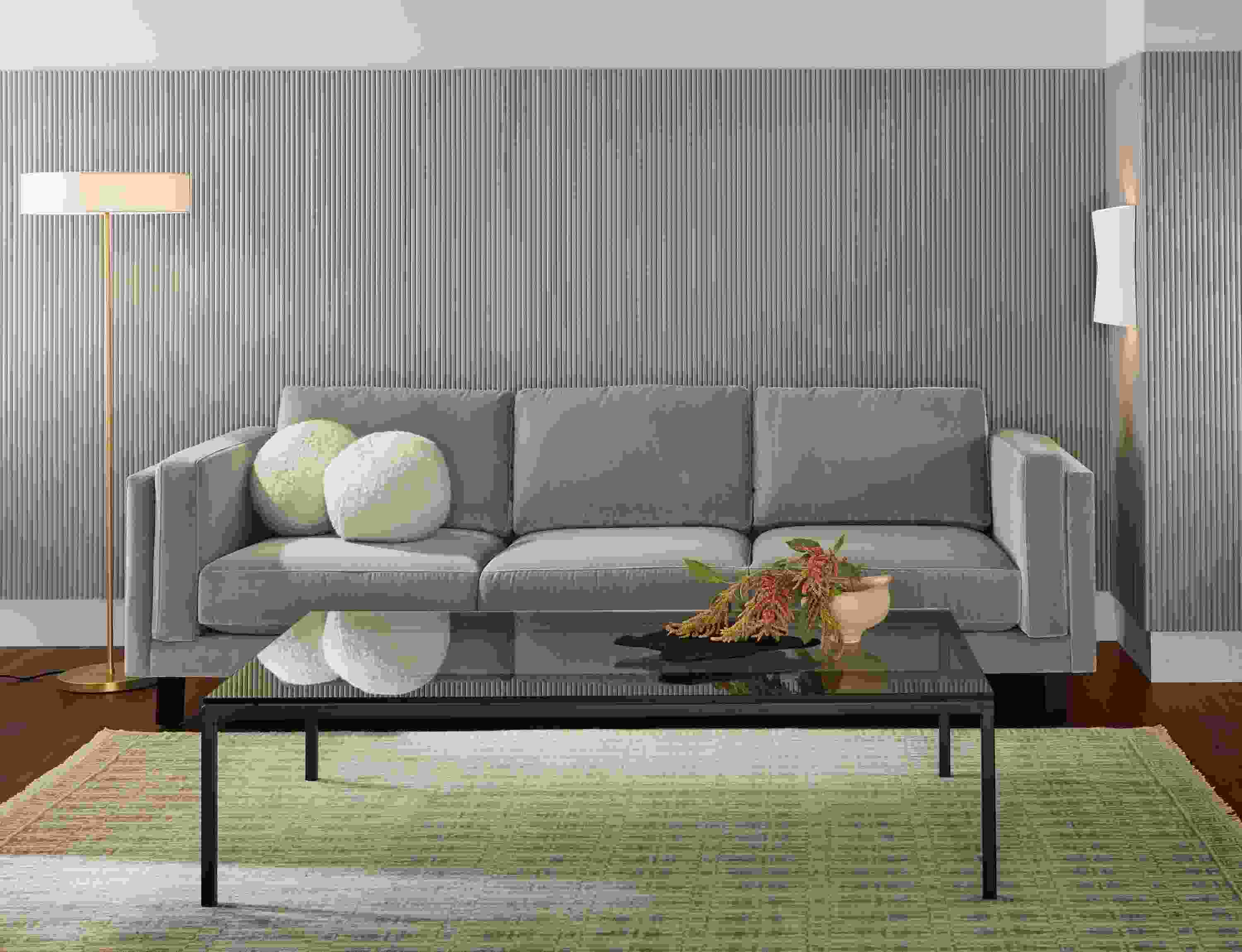 Living room with Cade 101-wide 3-cushion sofa in banks cement and Tulum 6 by 9 rug in taupe.