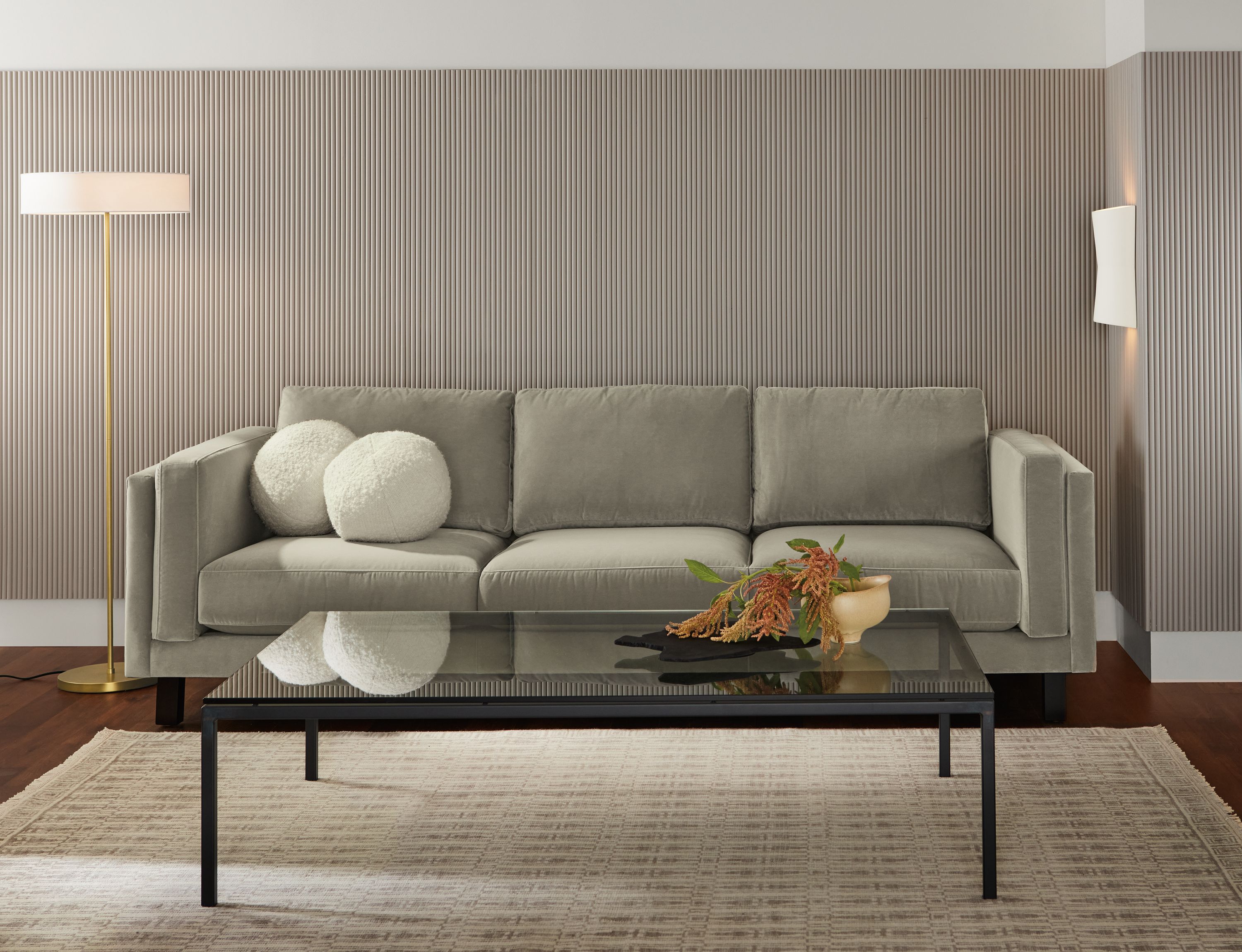 Living room with Cade 101-wide 3-cushion sofa in banks cement and Tulum 6 by 9 rug in taupe.