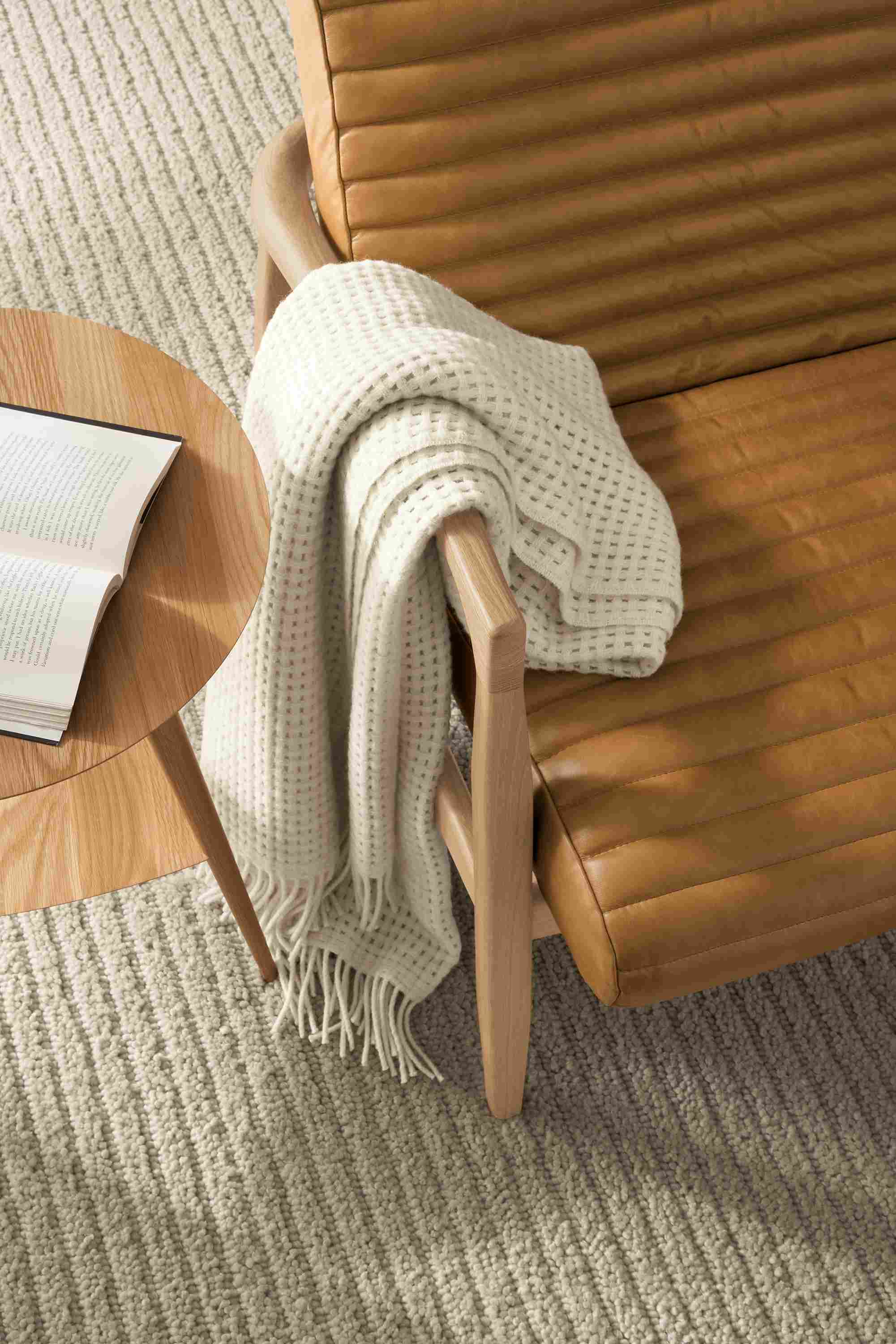 callan chair detail with rae end table, arden rug, and homage throw.