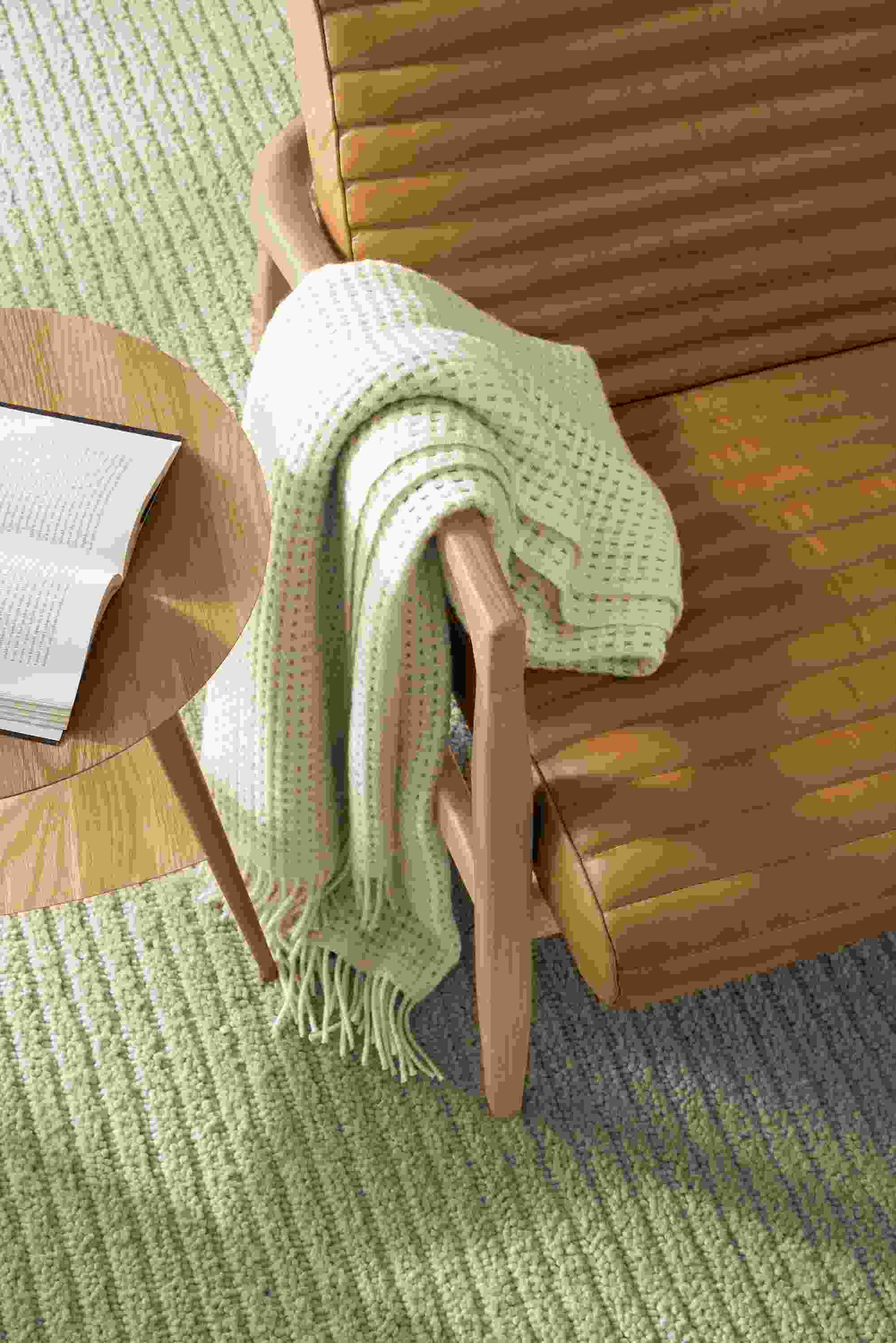 callan chair detail with rae end table, arden rug, and homage throw.