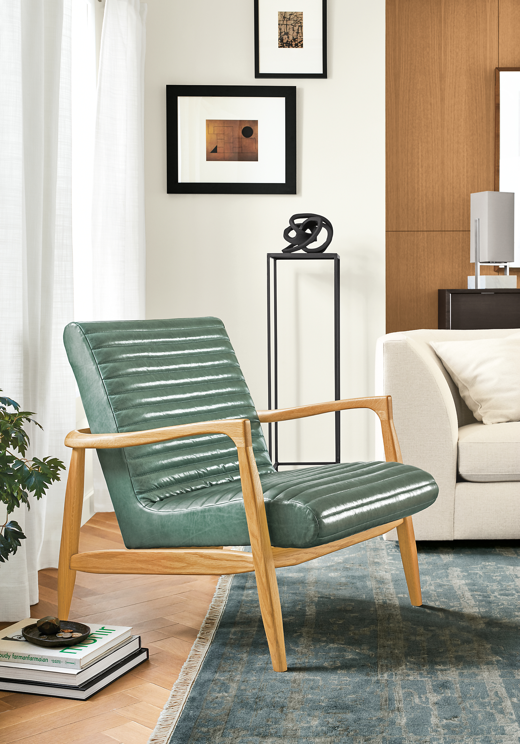 Detail of Callan chair in white oak and Vento teal leather in living room setting.