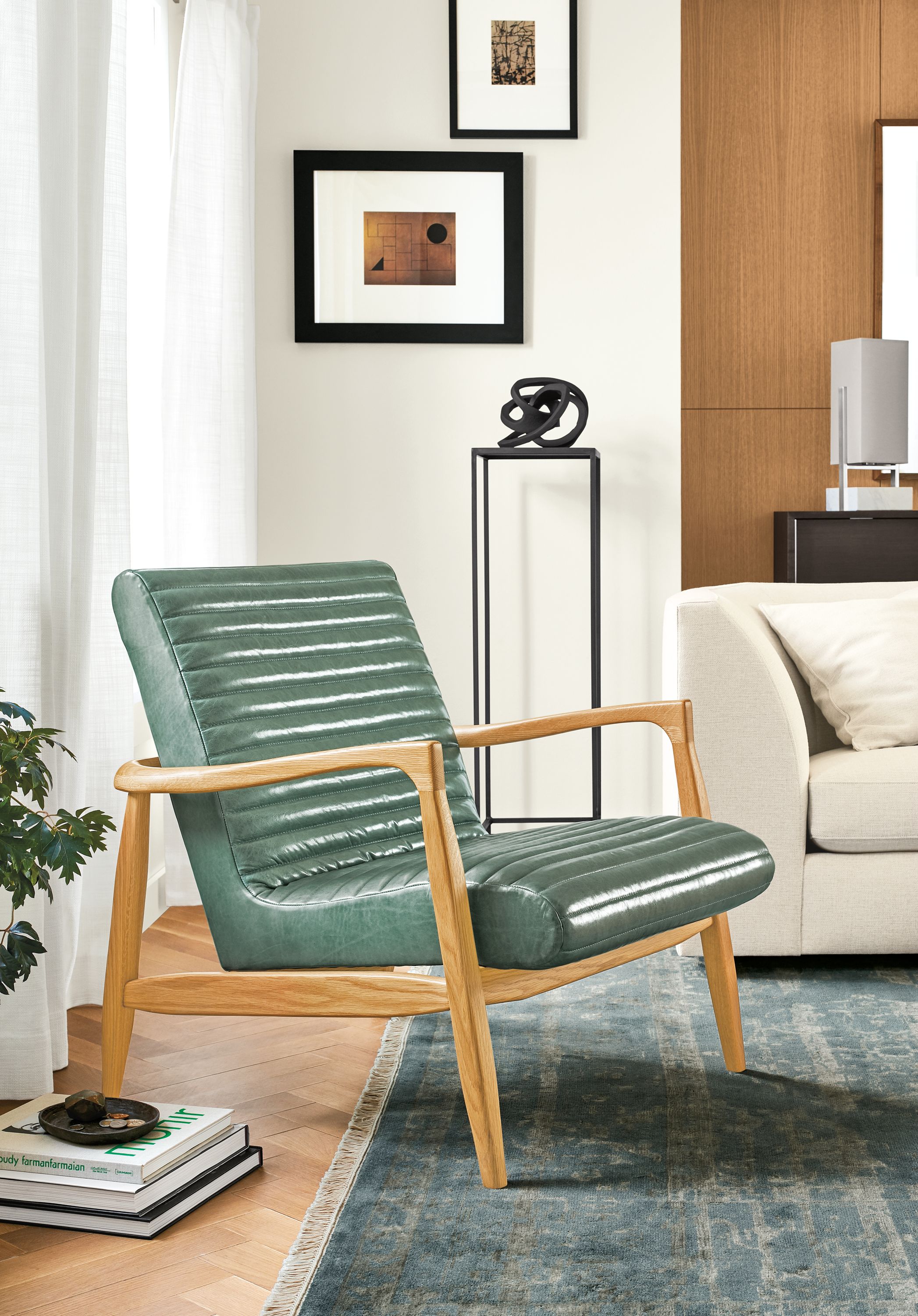 Detail of Callan chair in white oak and Vento teal leather in living room setting.