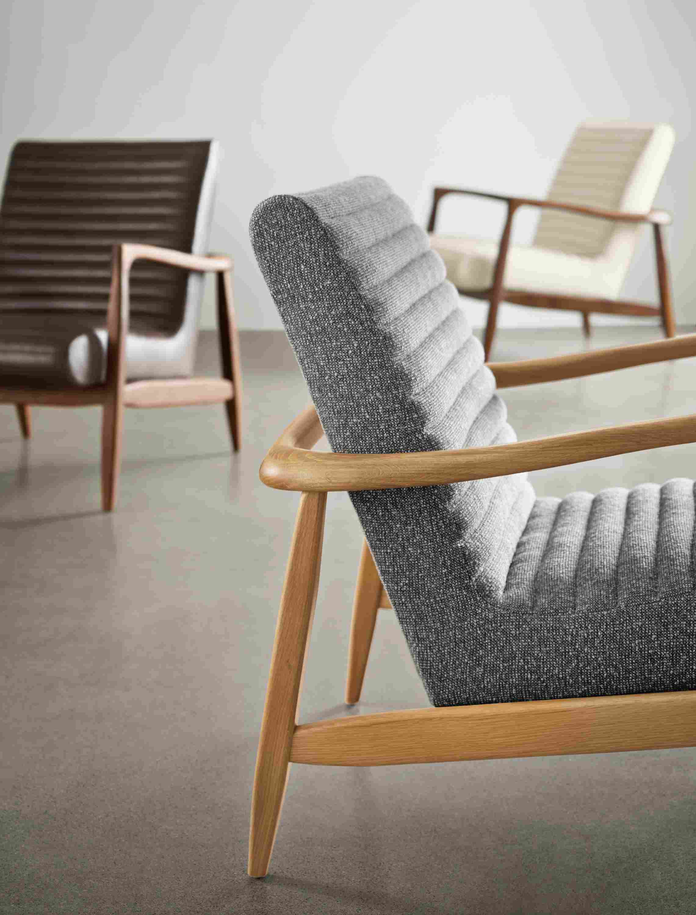 Group of Callan chairs in conley graphite, vento smoke leather and arin ivory.