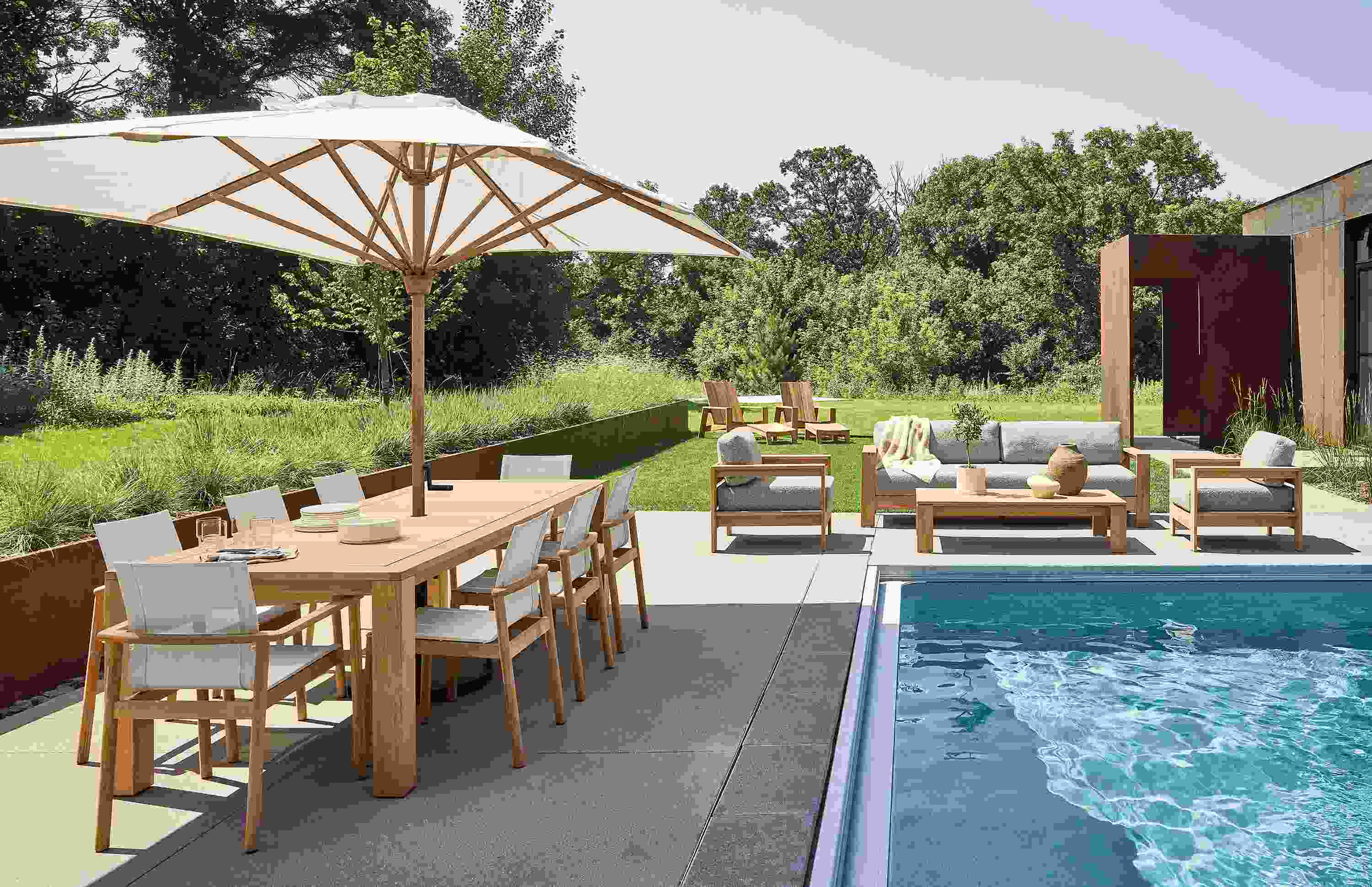 Pool area with Capri table, 2 Peri arm chairs and 6 Peri Side chairs in teak heartwood.