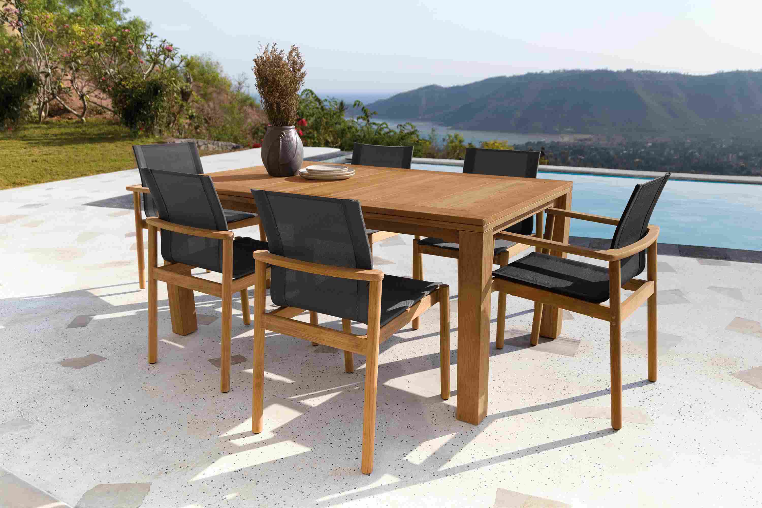 Outdoor patio with Capri 60 by 40 extension table in teak and Peri Chairs with Slate Sling..
