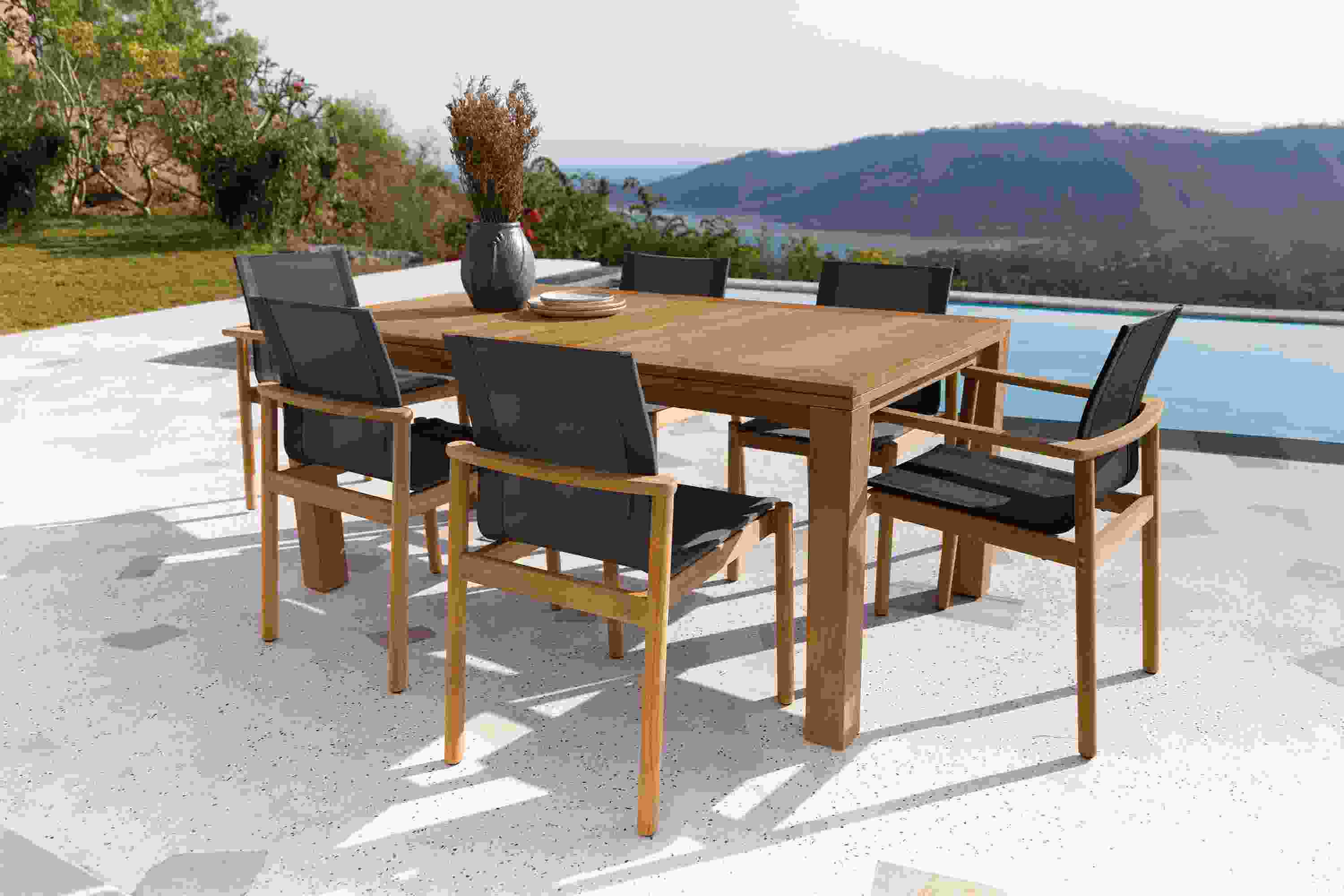 Outdoor patio with Capri 60 by 40 extension table in teak and Peri Chairs with Slate Sling..