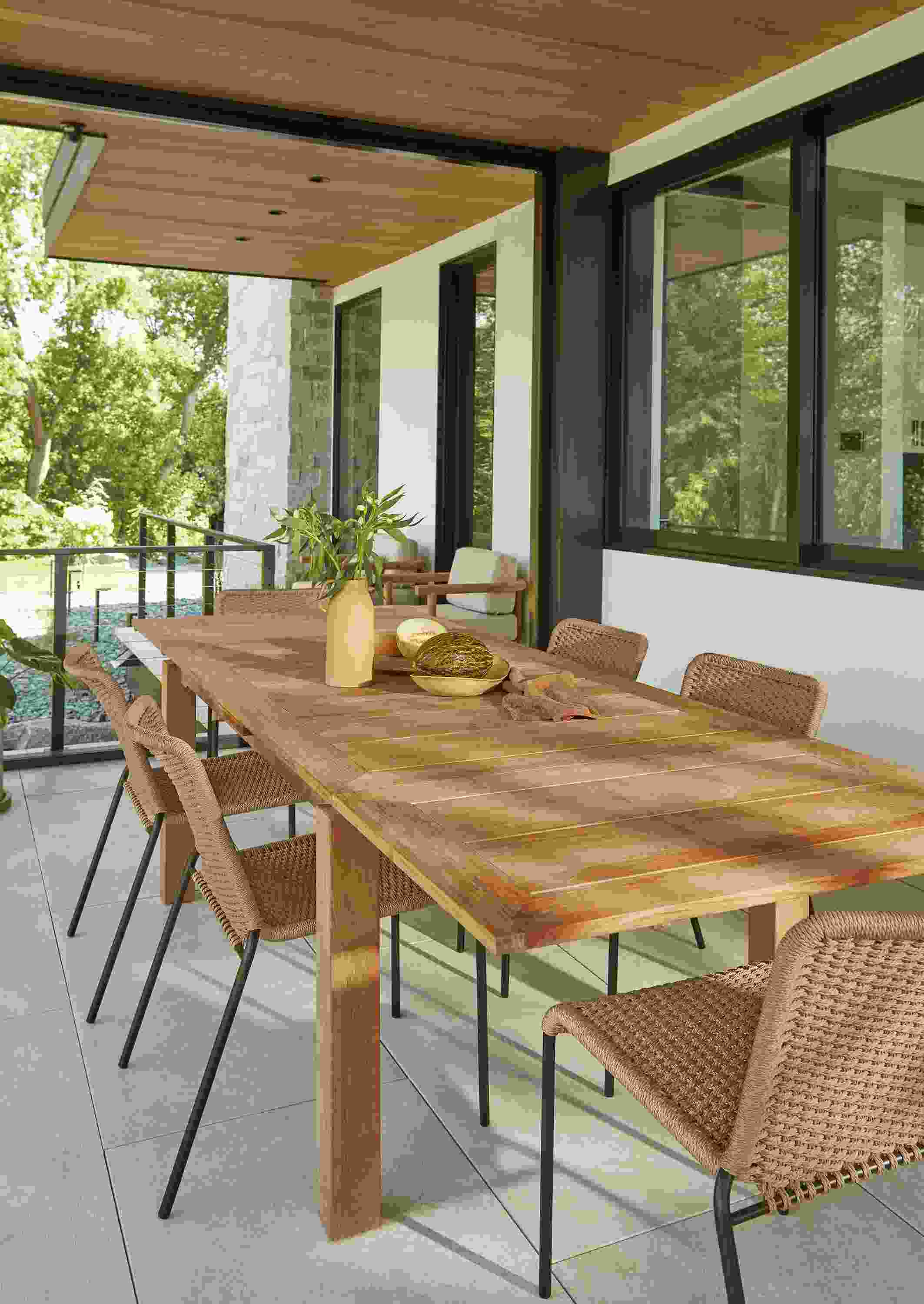 Veranda with Capri extension table in teak heartwood and Clea side chairs in black and natural cording.