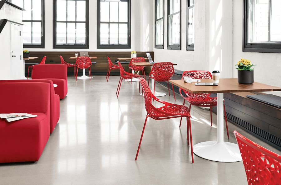 Detail view of red Caprice side chairs in modern office.