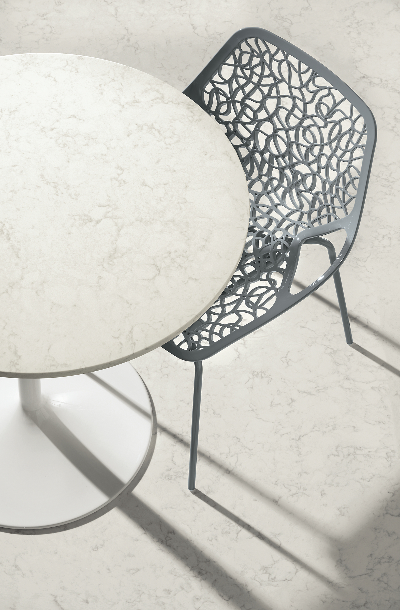 Detail of Caprice Side Chair in Grey and Aria 32-round table .