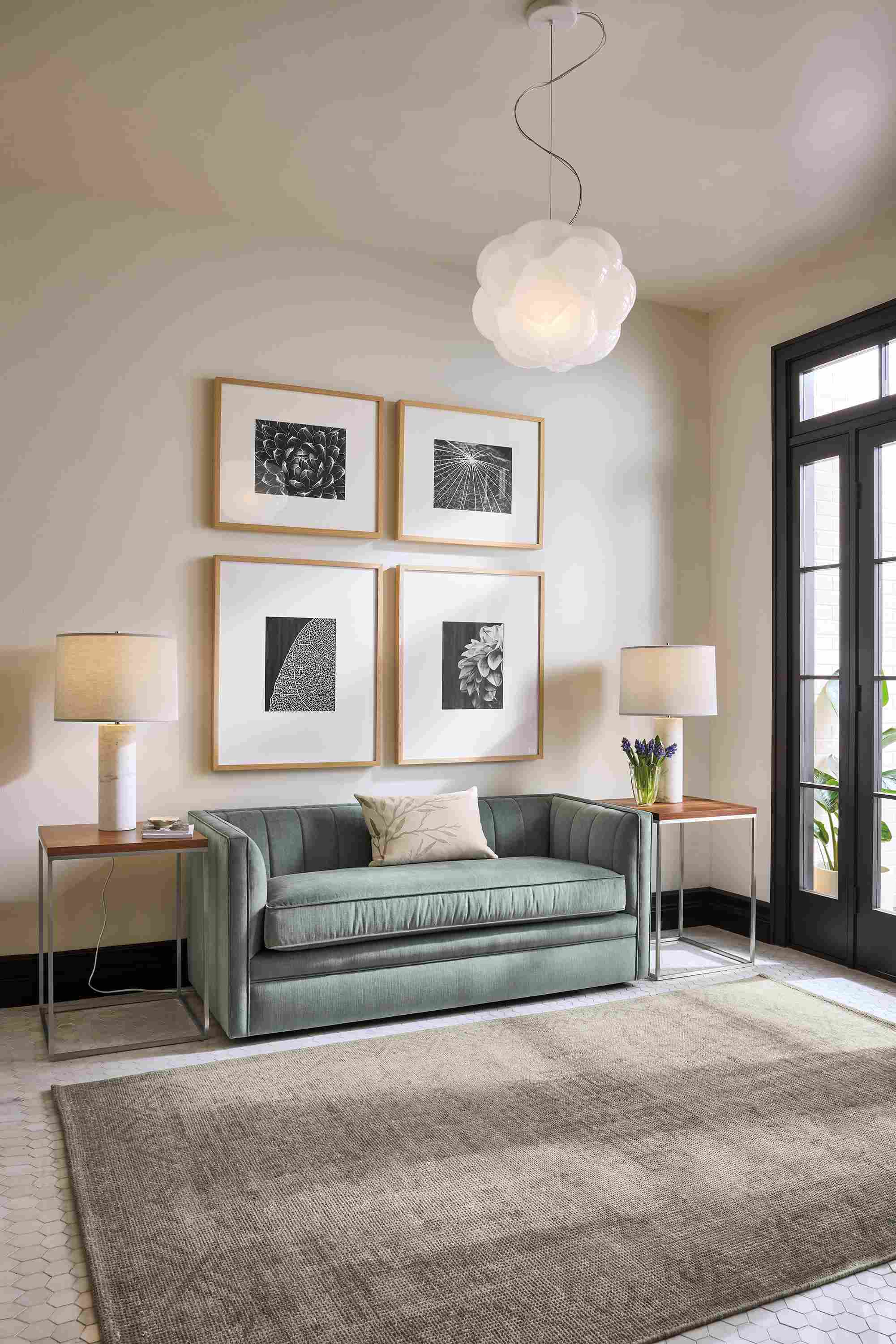 Living room with carlisle 60-wide bench in windsor cloud, 2 tyne end tables in stainless in walnut and amira rug in grey.