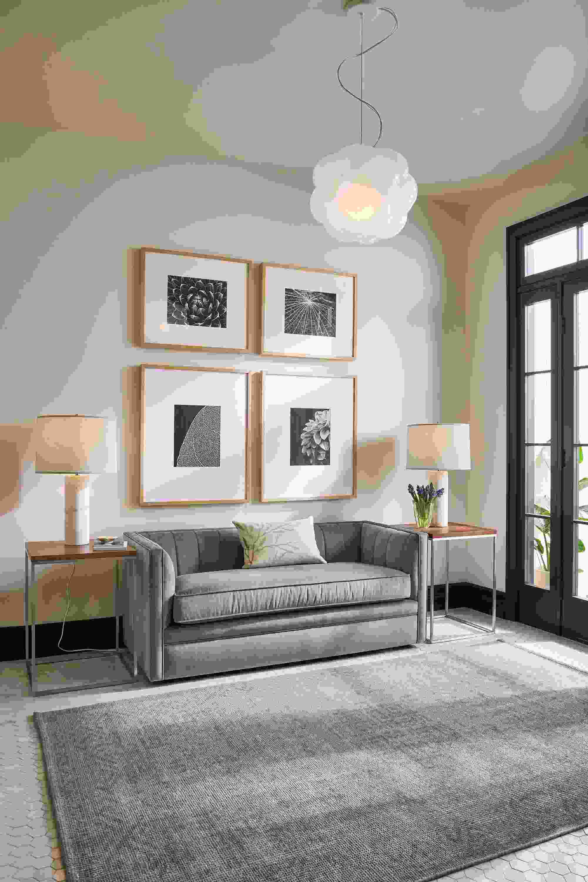 Living room with carlisle 60-wide bench in windsor cloud, 2 tyne end tables in stainless in walnut and amira rug in grey.