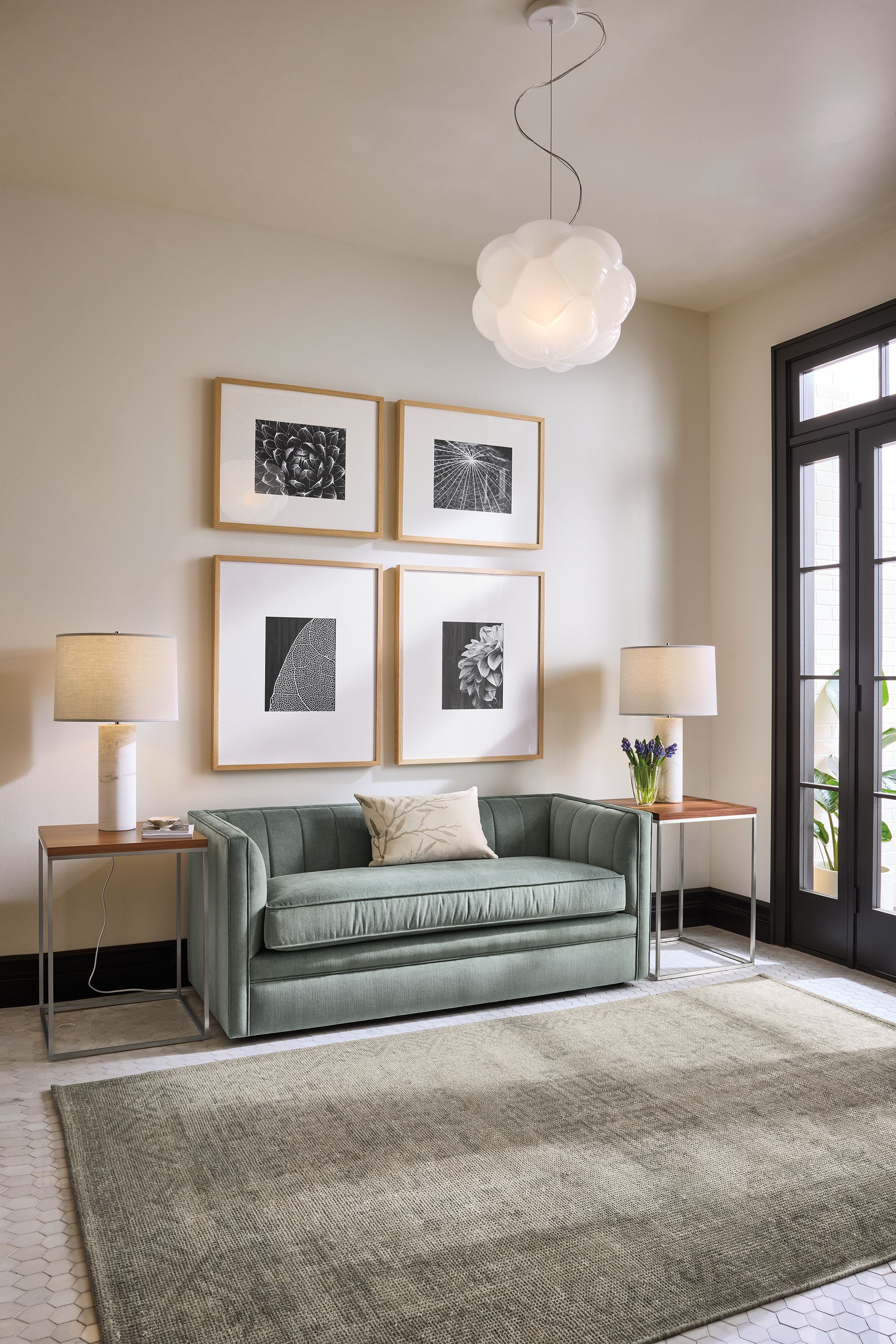 Living room with carlisle 60-wide bench in windsor cloud, 2 tyne end tables in stainless in walnut and amira rug in grey.