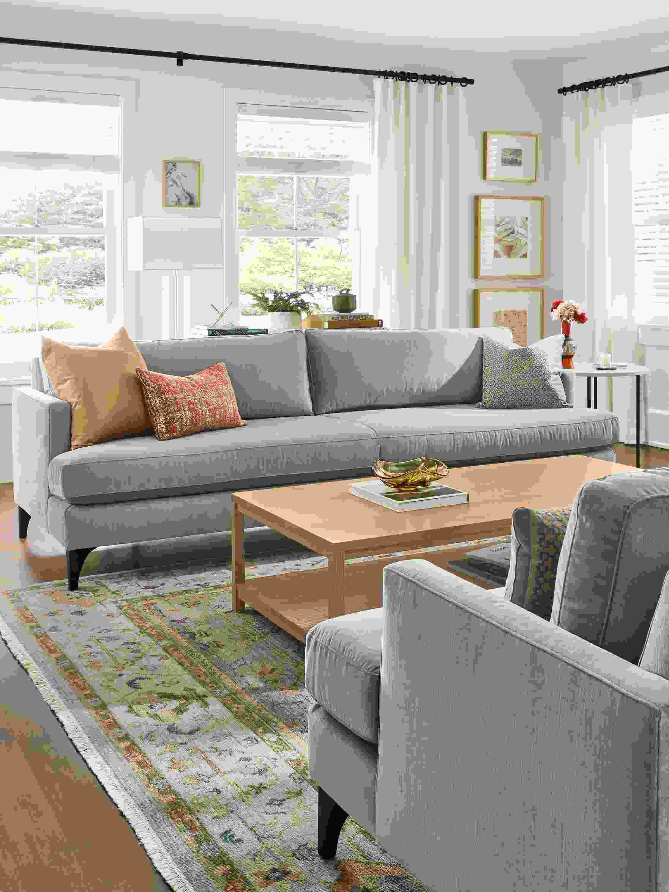 Living room with 2 carlton bench-cushion sofas in windsor cloud, clark coffee table in rye on red oak and sundar rug in sky.