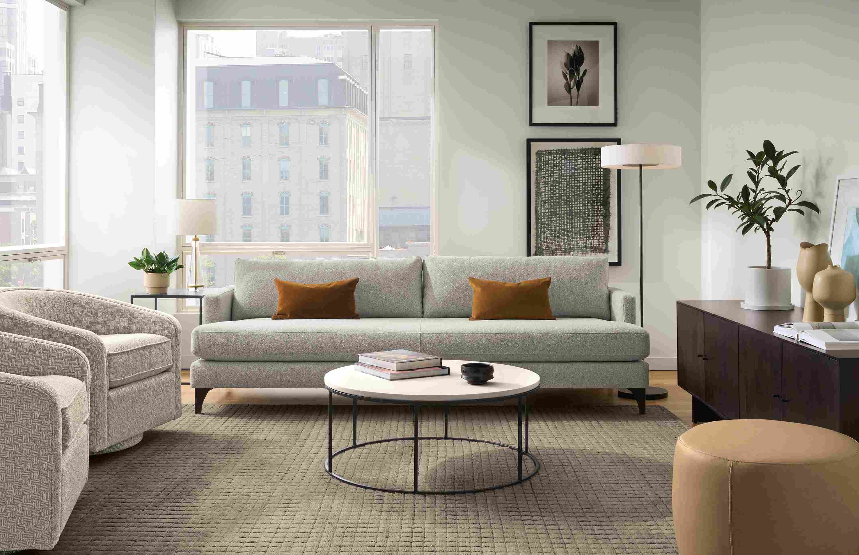 Living room with Carlton 96-wide bench-cushion sofa in Conley Grey and 2 Amos swivel chairs in Wexford Flax.