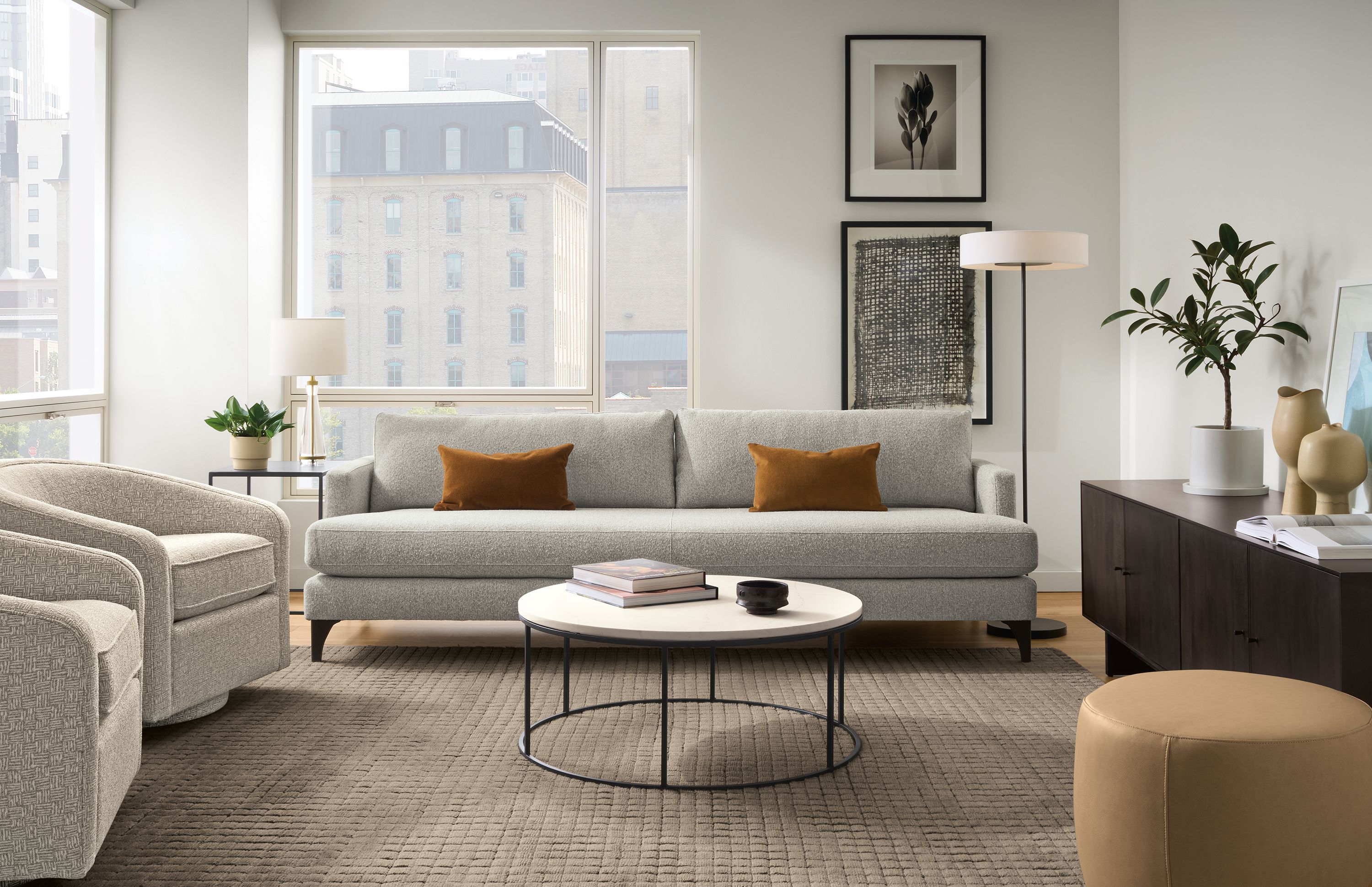 Living room with Carlton 96-wide bench-cushion sofa in Conley Grey and 2 Amos swivel chairs in Wexford Flax.