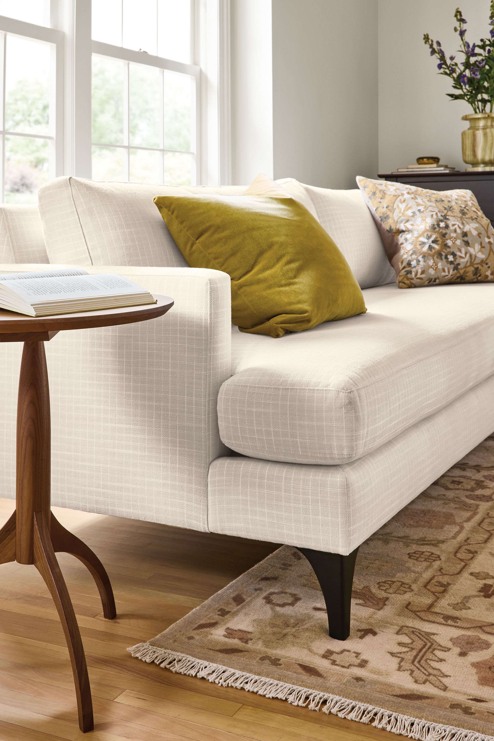 Living room with detail of Carlton 96-wide sofa in Prado Natural and Adams round end table in walnut.
