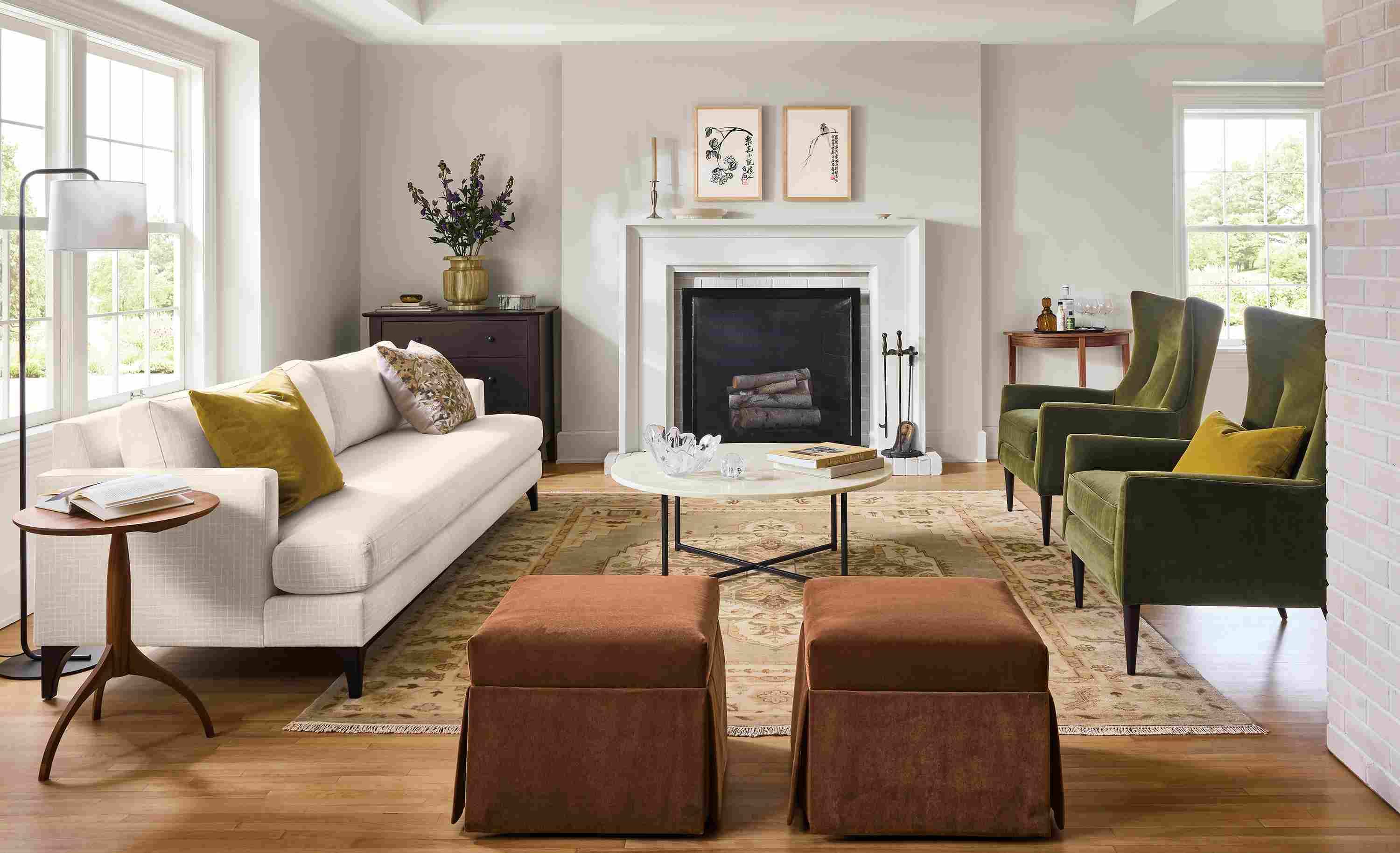 Living room with Carlton 96-wide sofa in Prado Natural, 2 Bradford chairs in Redding Olive and Heriz rug in Opal.