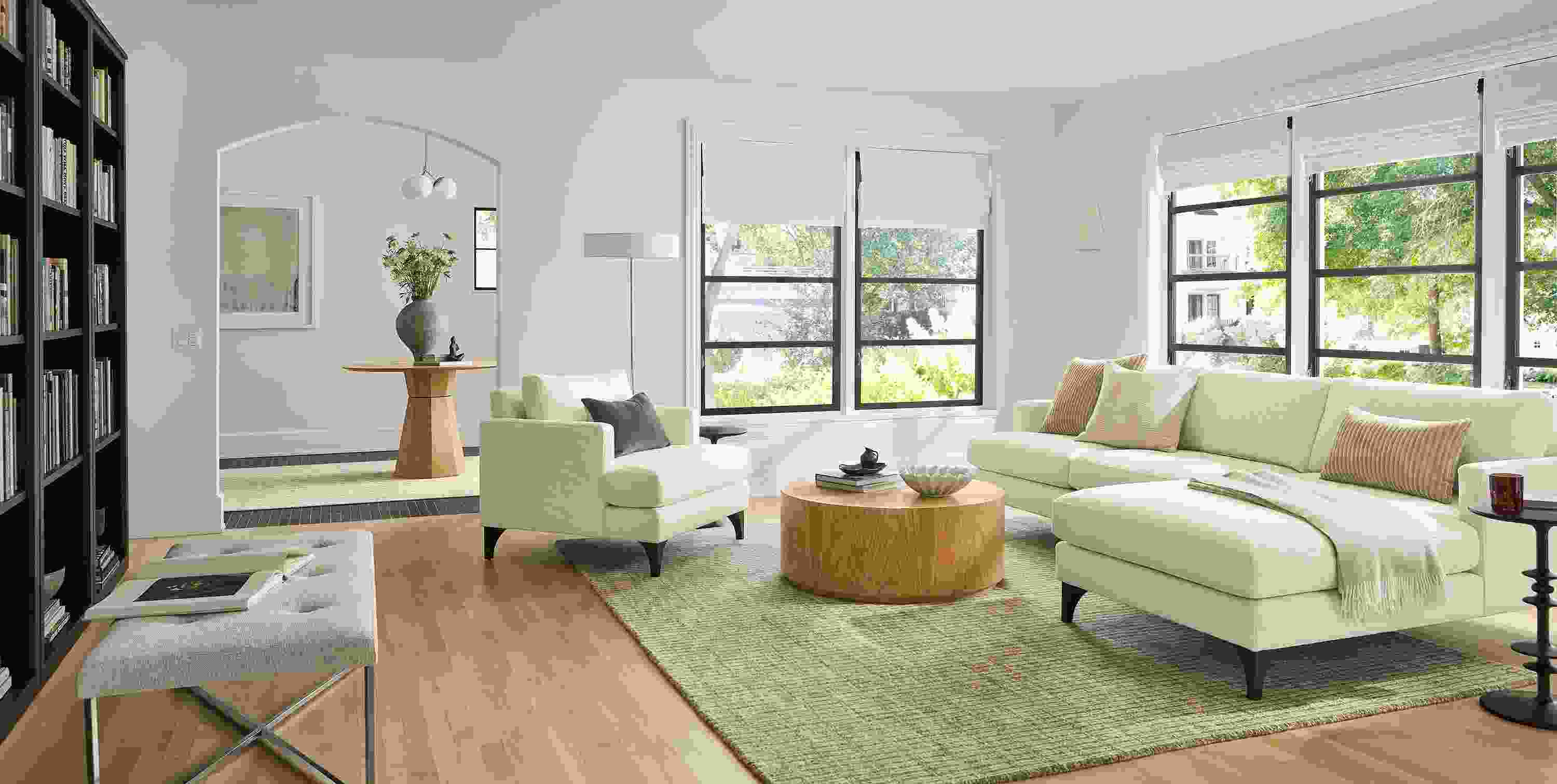 Living room with Carlton 100-wide chaise, and Carlton chair in Orla White, Liam 36 diameter coffee table in white oak.