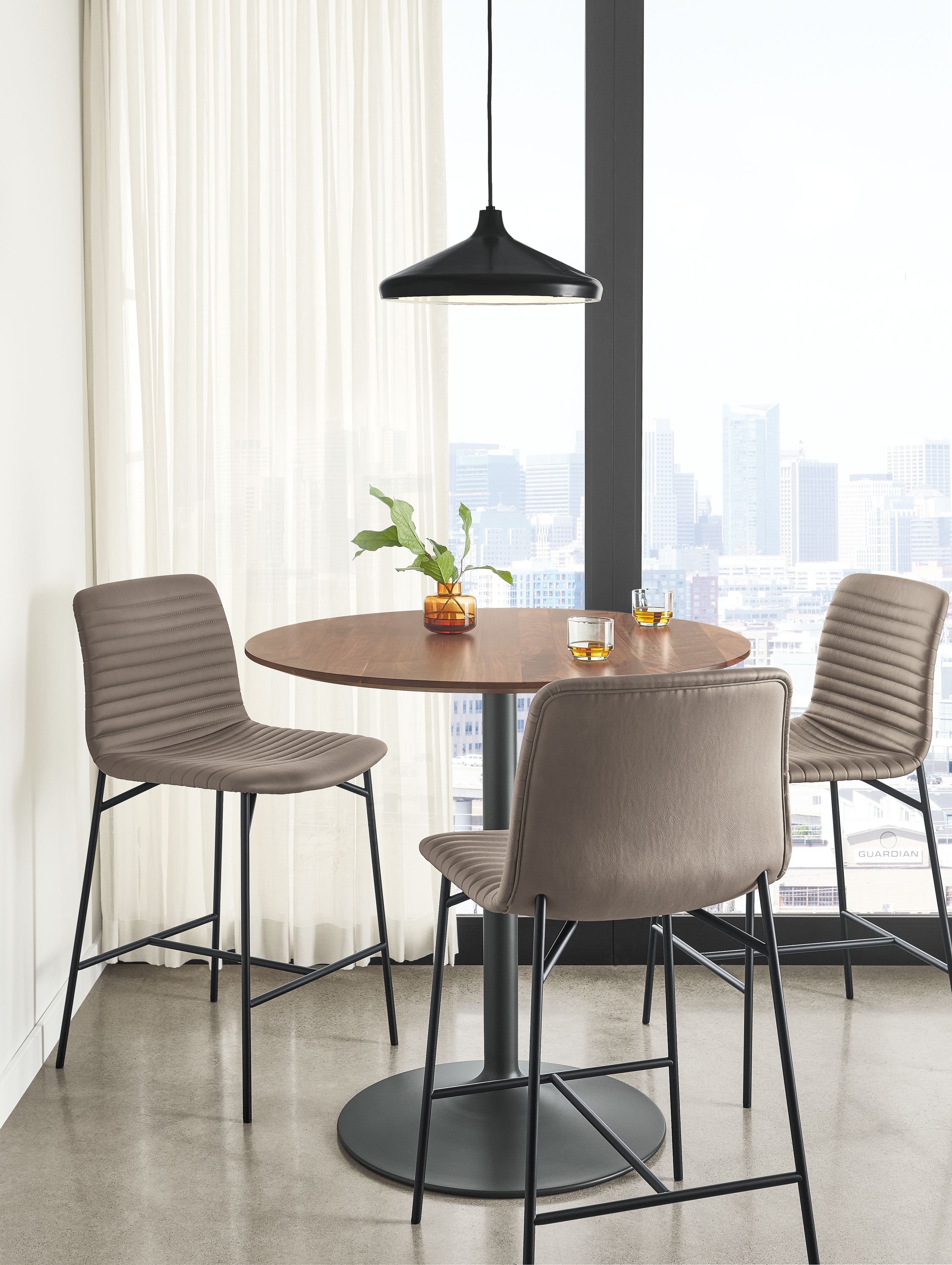 Detail of 3 synthetic leather Cato counter stools in Putty at round counter table.