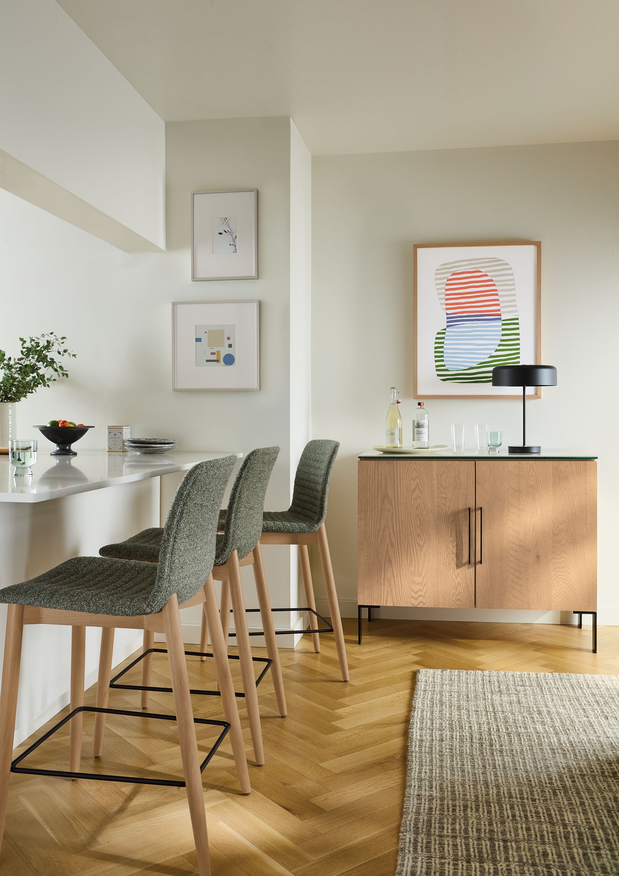 Counter seating area with 3 cato counter stools in zavin pine and rye on red oak and Kenwood storage cabinet in rye on red oak.
