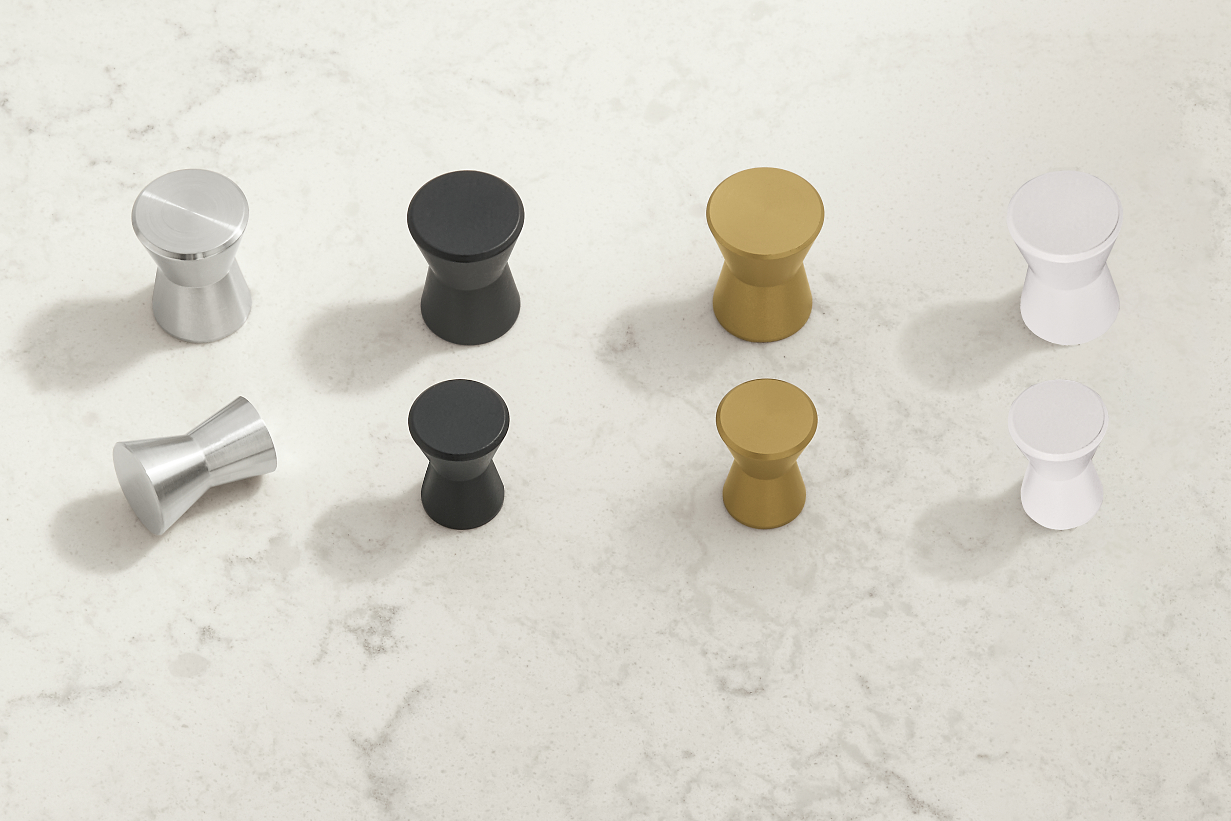 Celia knob collection in stainless steel,graphite,brushed gold and white.