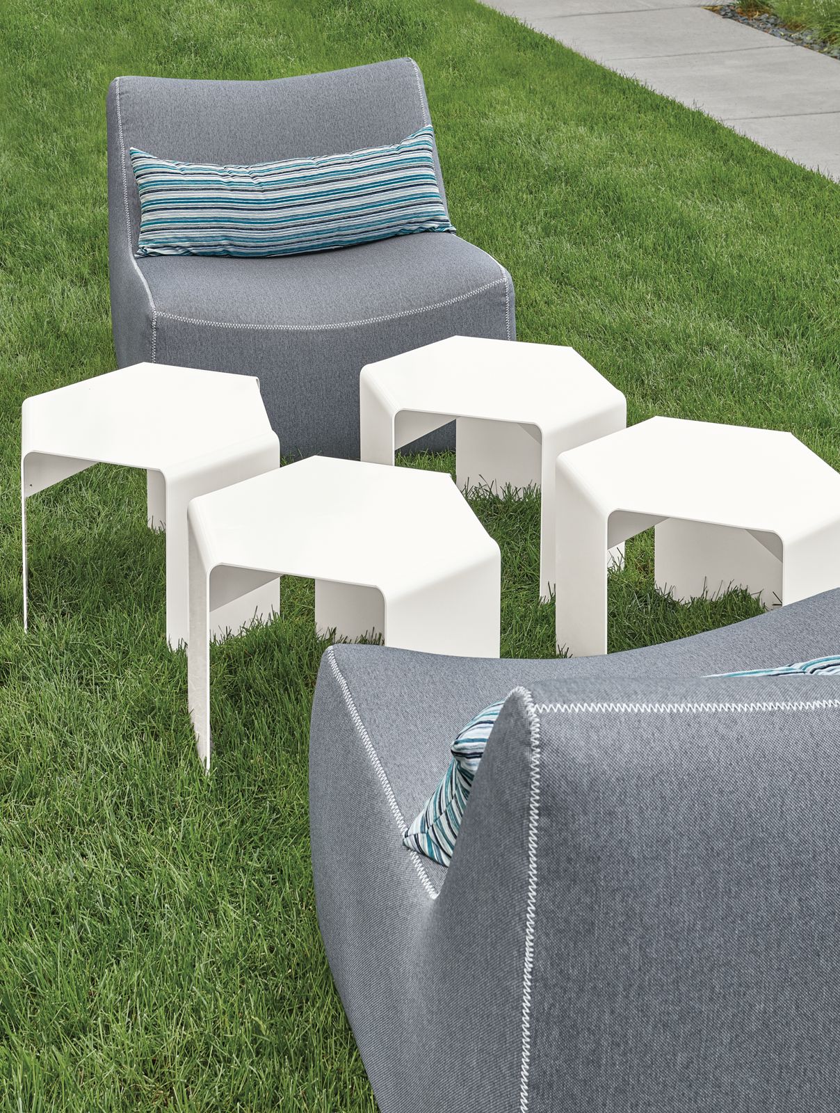 Detail of Cell outdoor side tables in white and Maya chairs.