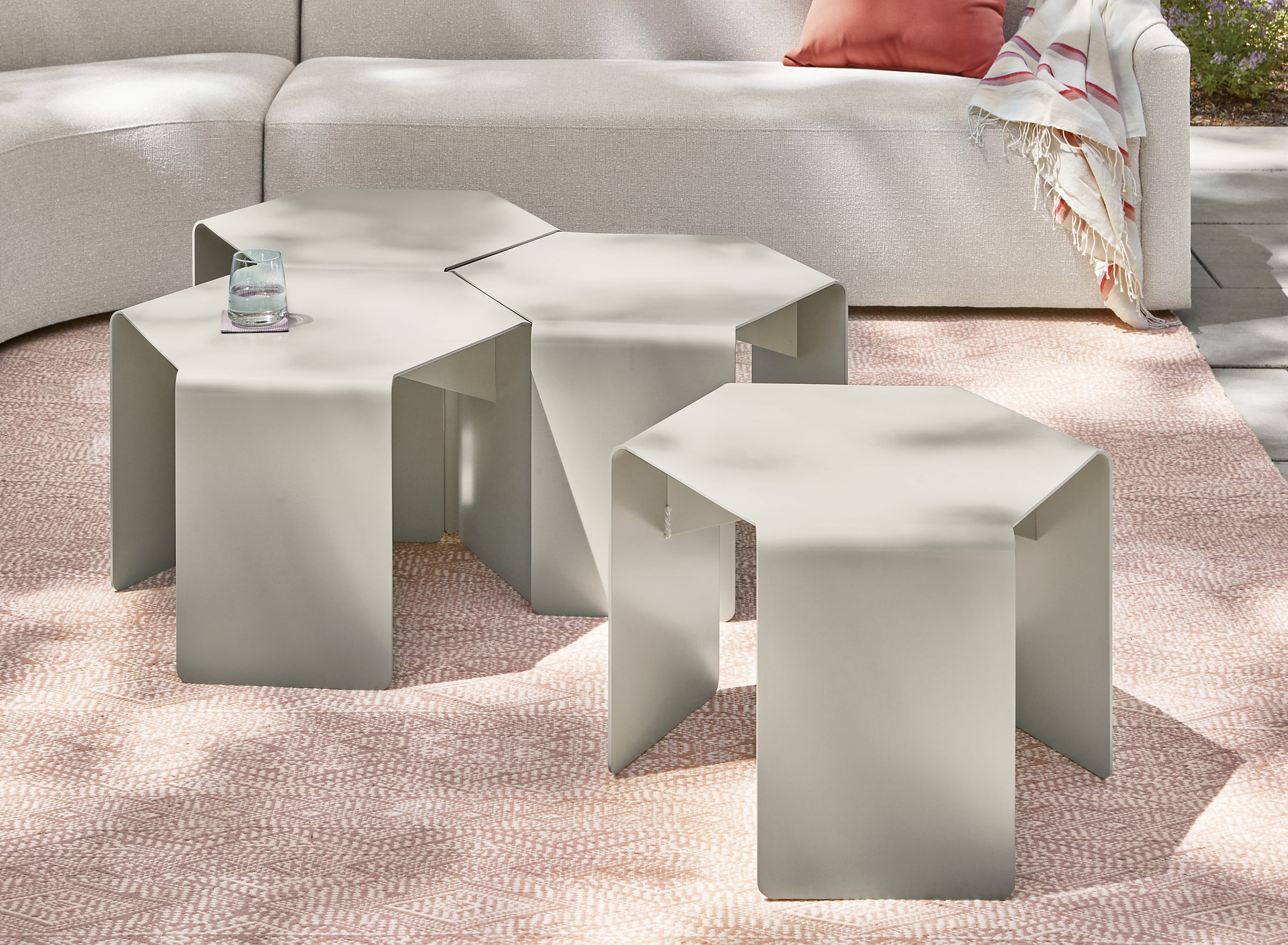 Cell outdoor side tables in taupe, Arris sectional and Fara rug in clay.