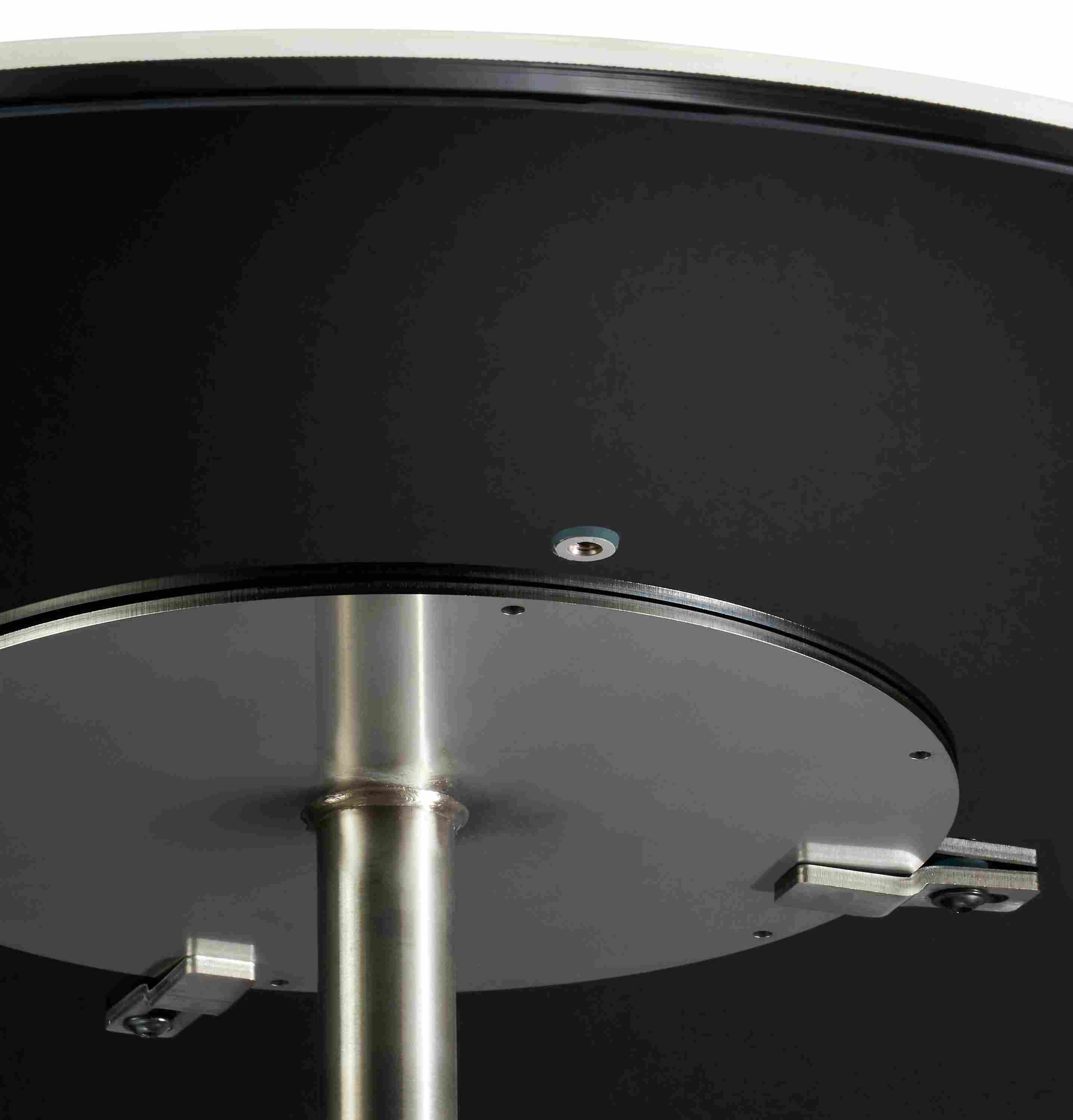 underside detail of round ceramic top showing base attachment.