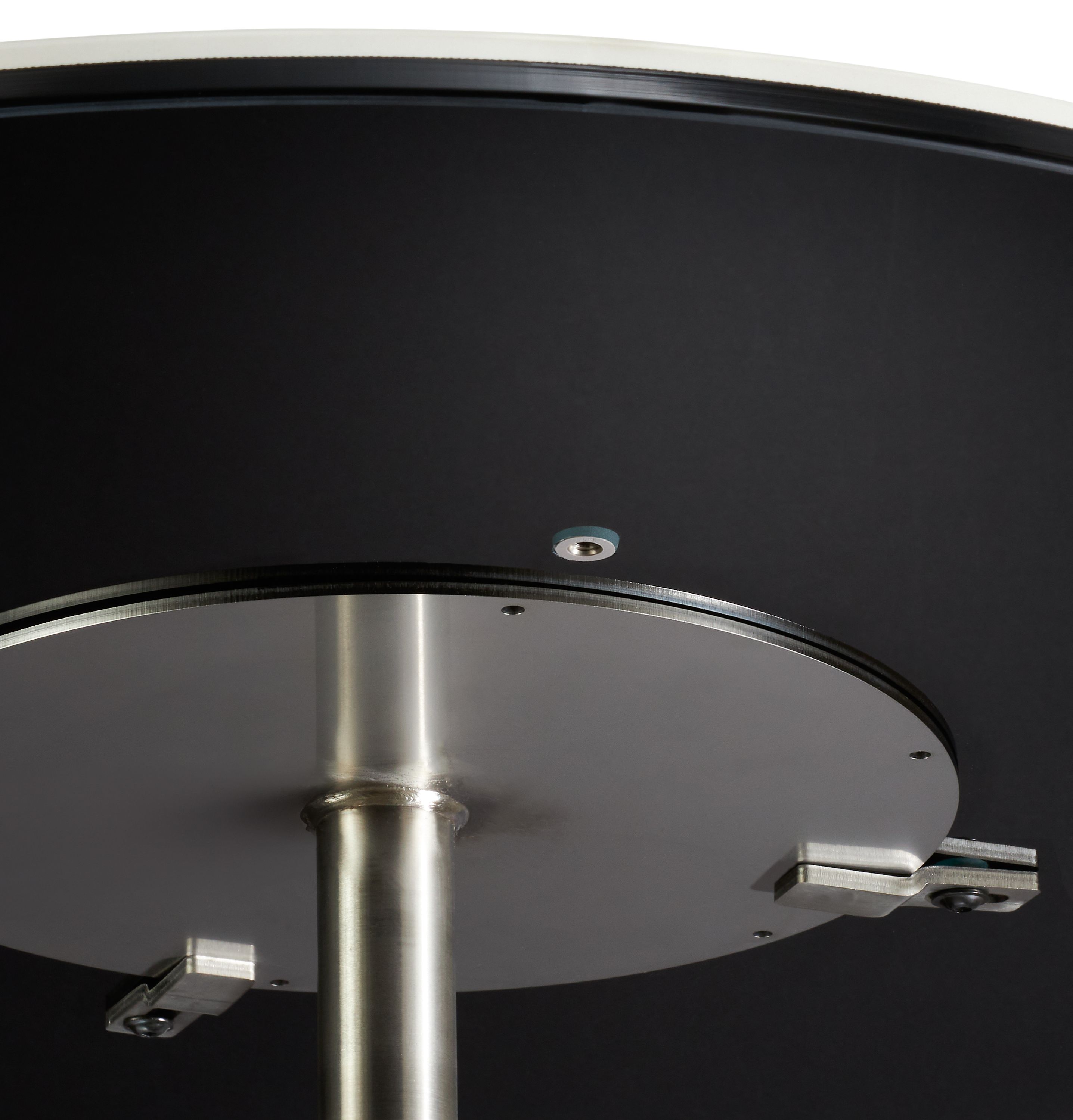 underside detail of round ceramic top showing base attachment.