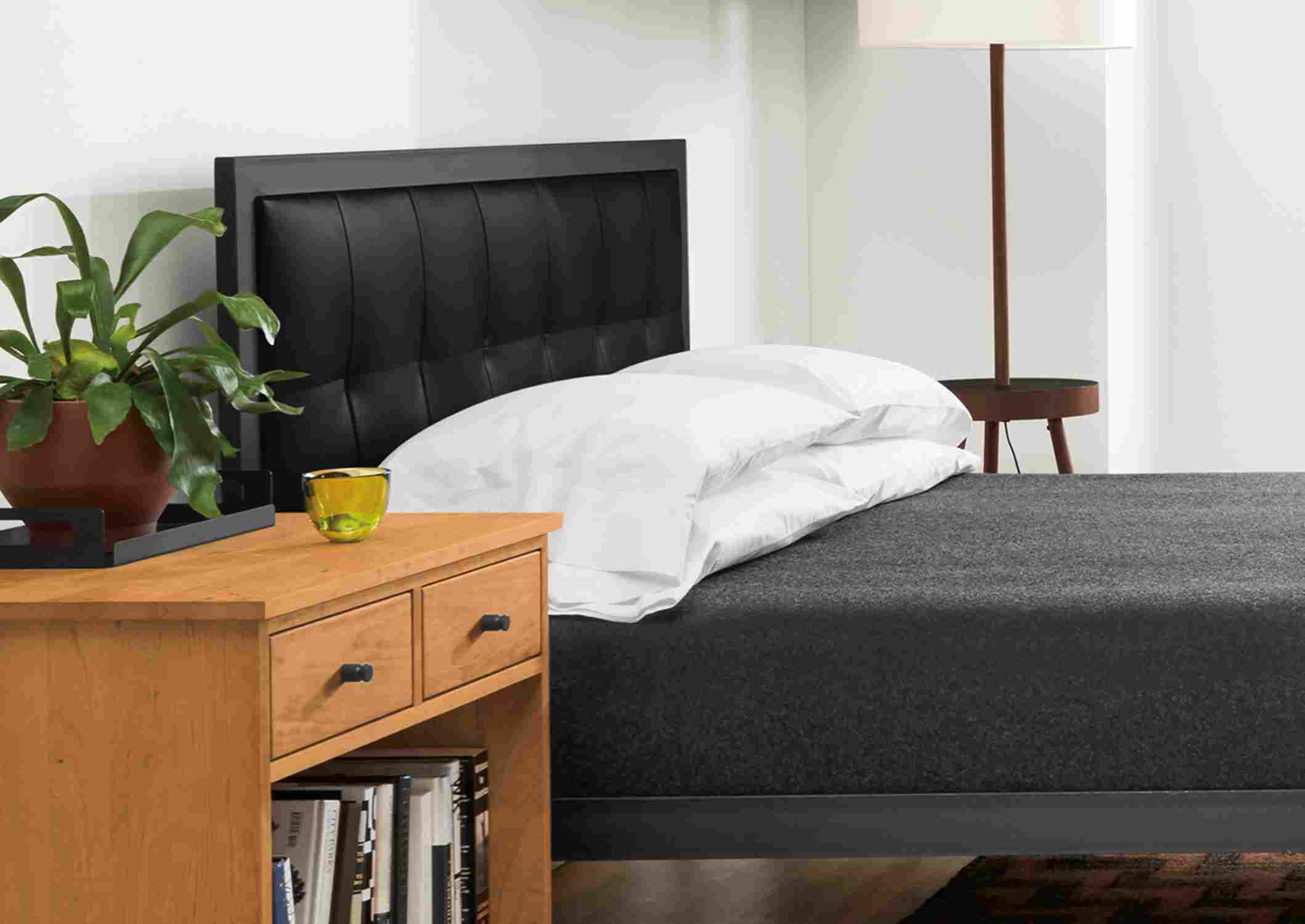 Detail of Chapman queen bed with Urbino Black leather headboard in large bedroom.
