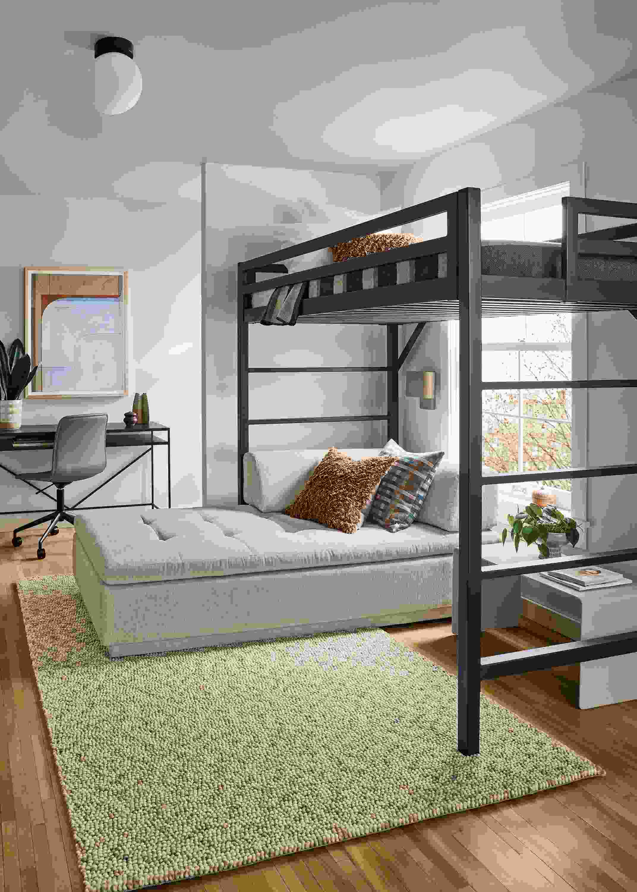 Room with a Chase twin loft bed and slim desk in natural steel, Cato office chair in Sarno Putty leather and Hastings rug in ivory/taupe.