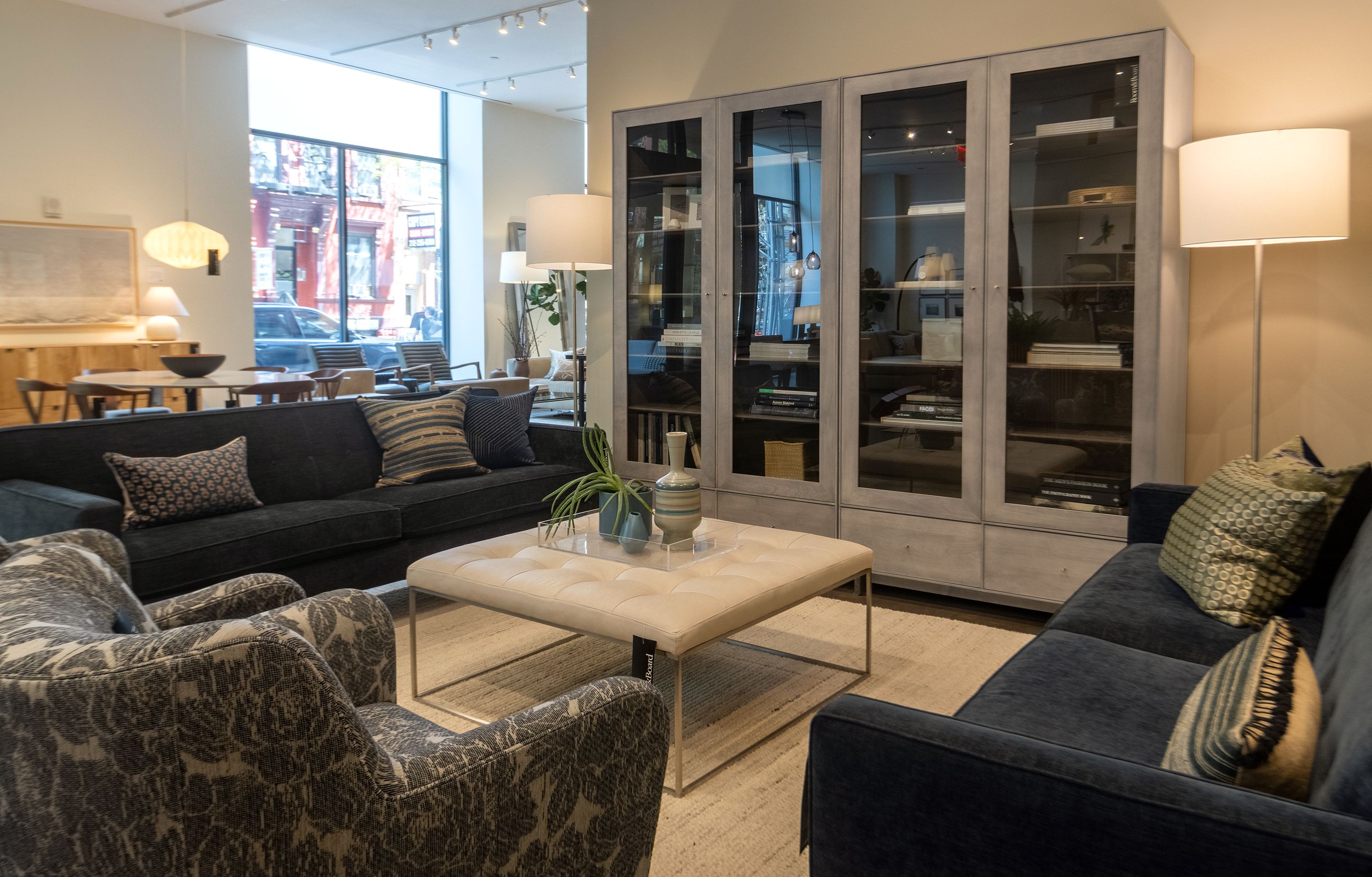 Store photo featuring a sitting area with 2 Andre sofas in Mori Navy and 2 Lily swivel chairs in caldwell navy.