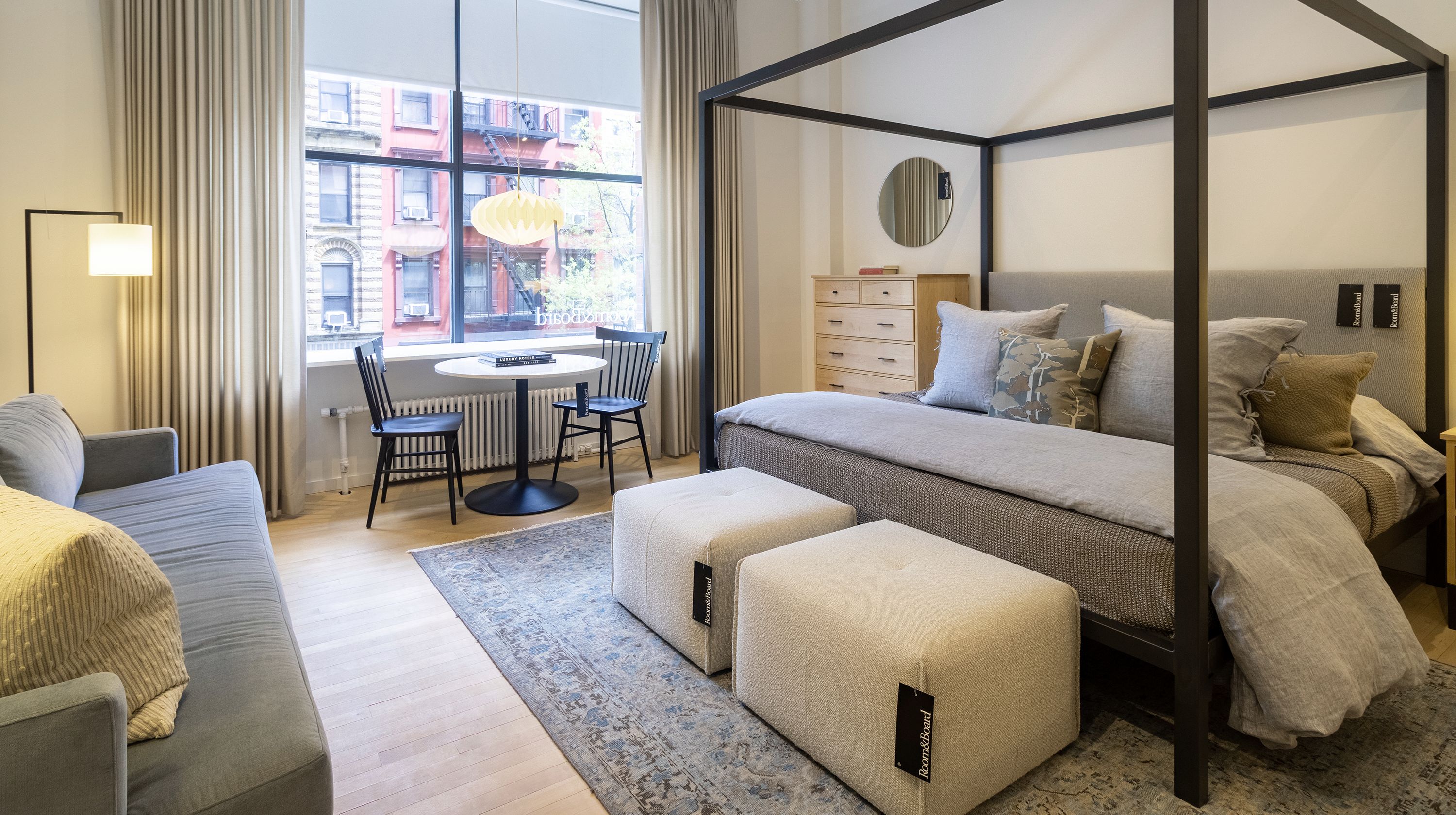 Store photo with an Architecture King bed in Derry Cement and natural steel and 2 Dupree ottomans.